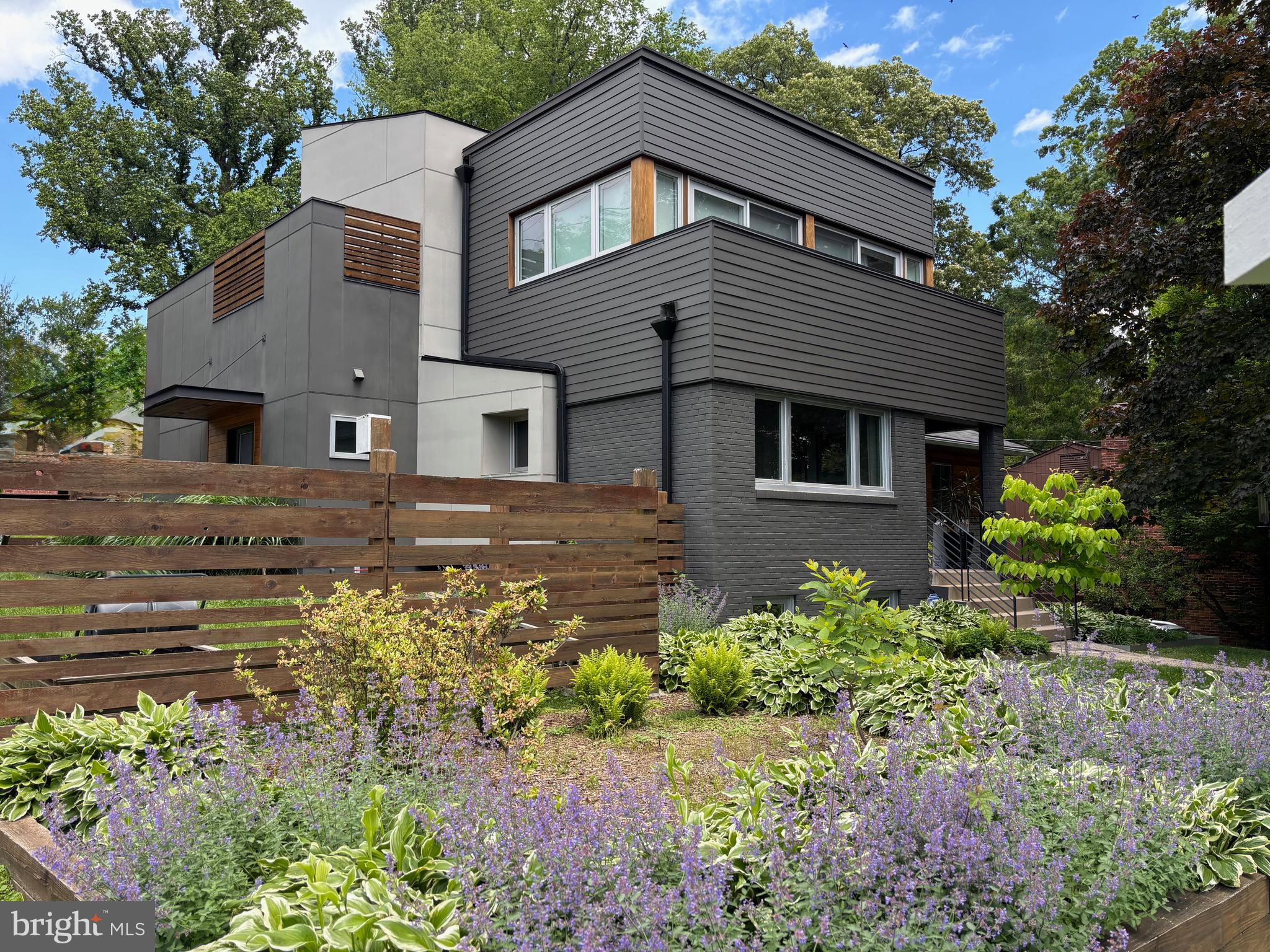 Welcome to this luminous and thoughtfully designed residence that perfectly balances contemporary living with versatile functionality. 

*MAIN LEVEL LIVING:
The heart of this home showcases an expansive open-concept layout where the family room, dining area, and gourmet kitchen flow effortlessly together, extending seamlessly to the outdoor lounge and beautifully landscaped garden—ideal for both intimate gatherings and grand entertaining.

The main floor offers incredible flexibility with two bedrooms, each featuring walk-in closets for abundant storage. One bedroom includes the luxury of a private ensuite bathroom, making it perfect for guests or multi-generational living. 

*UPPER LEVEL SANCTUARY:
Ascend to your private retreat featuring a spacious primary suite with a spa-inspired bathroom designed for relaxation and rejuvenation. Two additional bedrooms open to a charming balcony, sharing a beautifully appointed dual-sink bathroom. This level is completed by a convenient laundry area and an inviting open sitting area—perfect for a home office, reading nook, or family lounge.

*LOWER LEVEL VERSATILITY:
The expansive lower level is a true standout, offering endless possibilities for work and play. This level features its own private exterior entrance and a full bathroom for complete independence. The welcoming lounge area flows into a substantial office space ideal for running a home-based business, while a separate kitchenette adds convenience for extended use. The dedicated fitness area provides room for all your wellness needs, while an additional flexible room can serve as a secondary office, studio, or expanded gym space. Direct access to the spacious garage adds convenience to this exceptional level. This has the potential to be reconfigured as a 2-bedroom apartment. 

*UNBEATABLE LOCATION:
Nestled in the highly coveted High Point neighborhood, this home enjoys a prime position between the prestigious communities of Westwood, Wood Acres, and Glen Echo Heights. You're just minutes from the vibrant Westbard Square, featuring an exciting collection of coffee shops, restaurants, green spaces, and convenient grocery shopping. As this development continues to expand, it's likely to boost property values throughout the area.

Beyond local amenities, the home offers easy access to the Capital Crescent Trail, perfect for cycling or walking to downtown Bethesda and Georgetown. Outdoor enthusiasts can quickly reach Glen Echo Park, the Potomac River, and the C&O Canal for recreation. Students attend the well-respected Walt Whitman High School and Pyle Middle School, while the acclaimed Wood Acres Elementary School is less than a mile away.