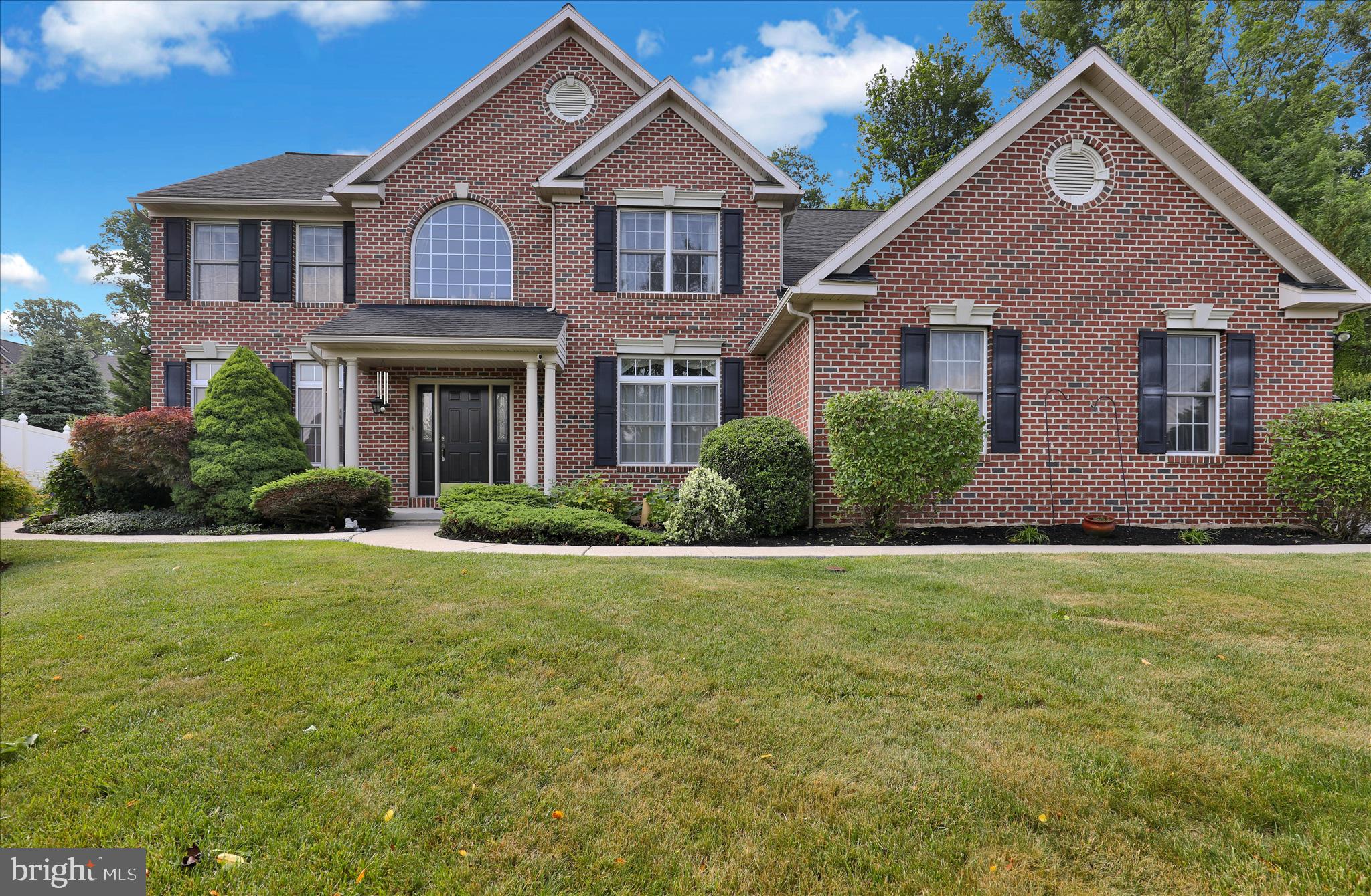 Set in a cul-de-sac on 1.26 acres within the Exeter Township School District, this stately brick home features  a professional office suite with a private side entry and a three-car garage and fenced backyard. A two-story foyer opens to the formal living room and dining room with hardwood flooring and 9' ceilings. The family room includes a gas fireplace and access to the patio, while the well-appointed eat-in kitchen offers stainless steel appliances, including a 5-burner gas stove and new microwave, Corian countertops, a walk-in pantry, and a patio door that leads to the outdoor entertaining area. The main level also includes a half bath, laundry room, and mud room. Adjacent to the family room, the professional office suite includes sound-buffering walls, a private office, waiting room, half bath, and separate exterior entrance.  A surround-sound speaker system extends throughout the main level and second-floor primary suite. The primary suite includes an ensuite bath, walk-in closet, and sitting room, while three additional spacious bedrooms share a full bathroom. The finished basement offers a rec room, kitchen, half bath, and flexible space for a hobby room, exercise area, or fifth bedroom, along with a large unfinished mechanical and storage room. Additional features include natural gas heat, newer central air conditioning, public sewer, and a new well.
