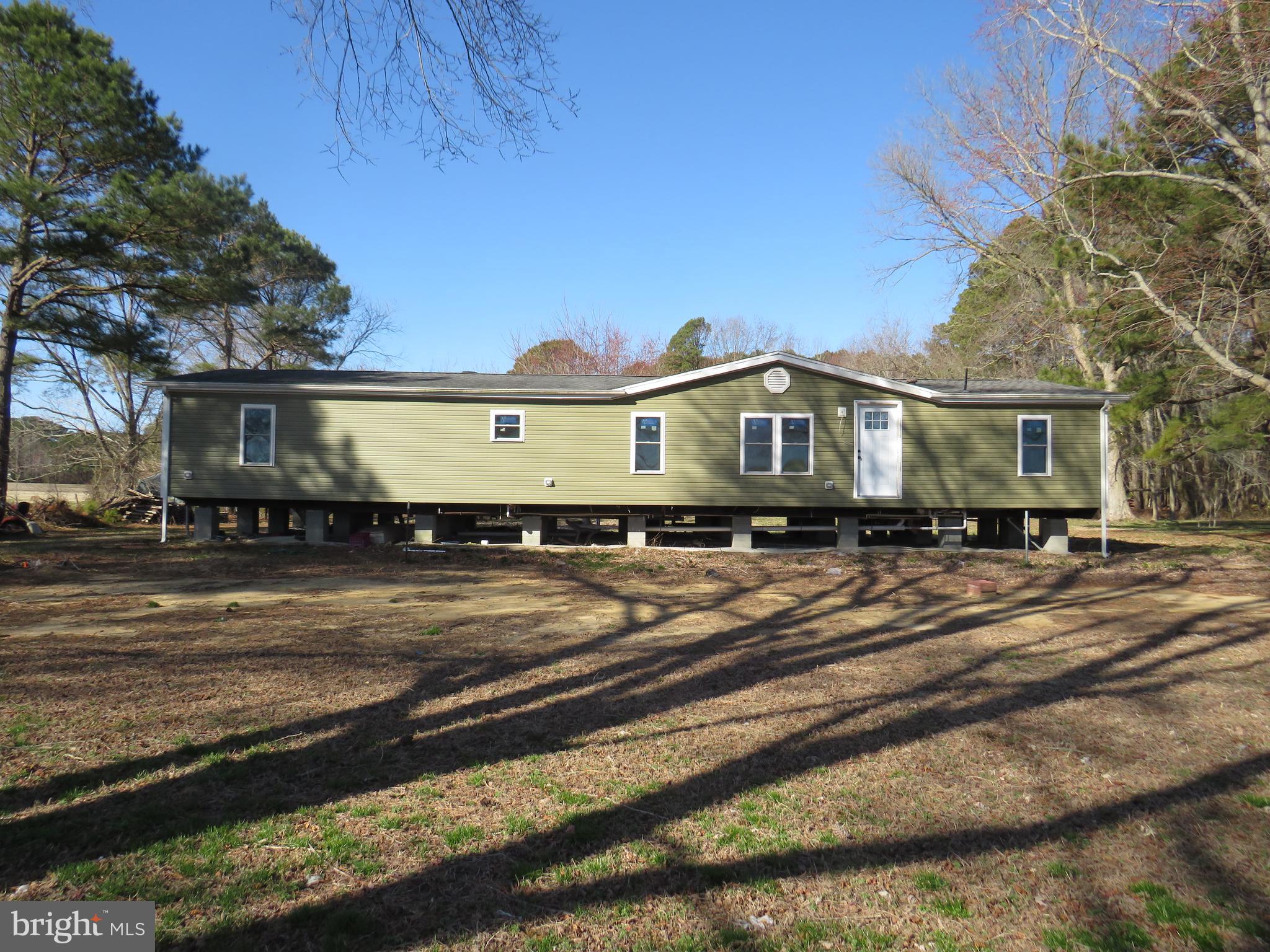 Project house!  This manufactured home has been completely gutted, with new interior walls, new drywall, wiring is pulled, panel box not completed, heat pump installed, but not completed, no plumbing fixtures are installed, just rough in.  Complete this to your specifications!  Large lot with 2016 installed BAT system,  existing 216 ft. deep well and electric .  First floor elevation (certificate available) is 10.5'.   1.75 acres somewhat overgrown, but in a great location.  Pole shed at rear of property needs work.   If you are a handy person, or not intimidated by a project, this property could be for you!  Permits have expired, so Somerset County Technical and Community Services must be contacted to know what must be done to proceed.