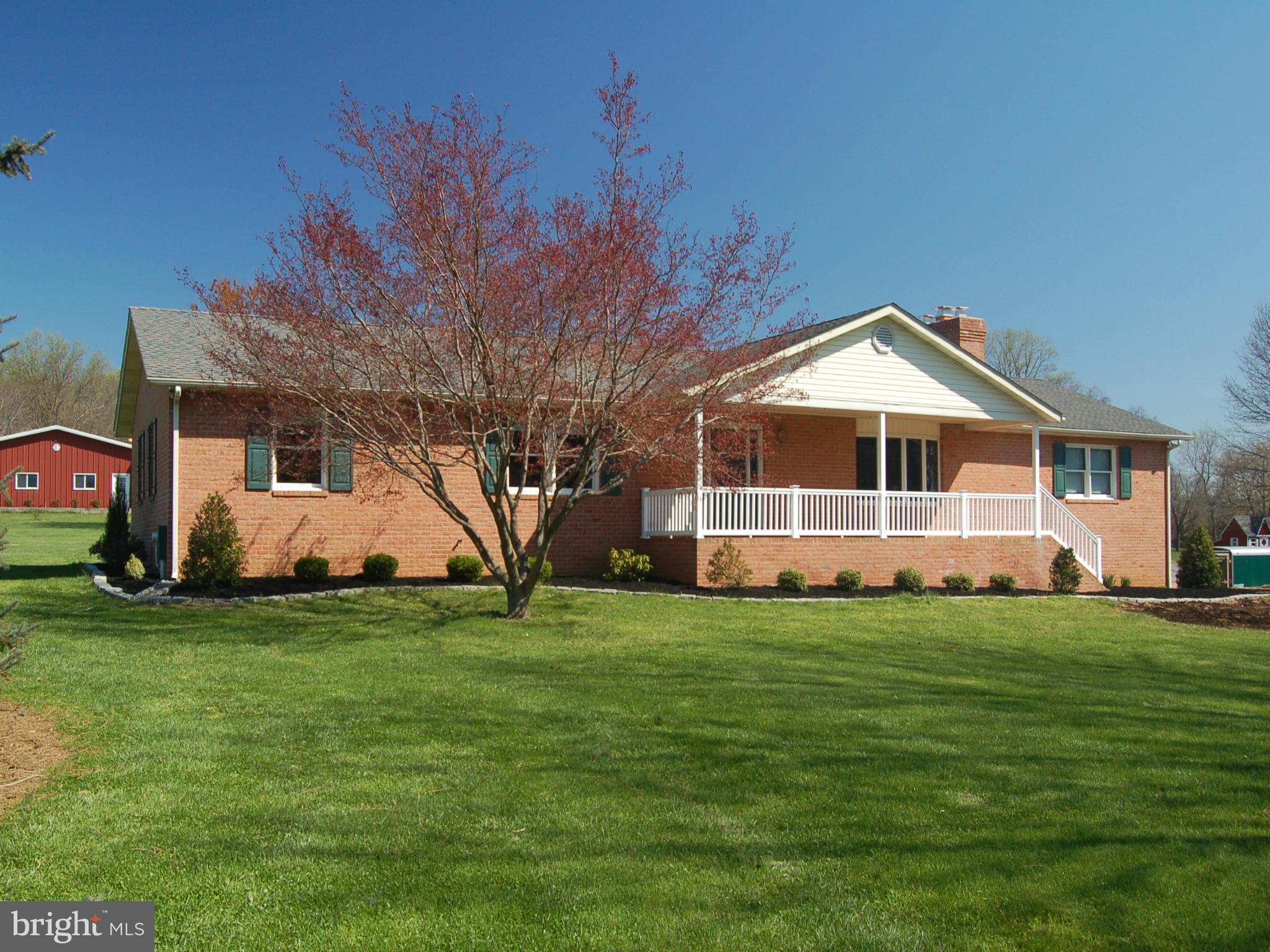 Impeccably maintained 5 BR brick rancher on over 5 acres. Long drive meanders back to quiet setting with views overlooking fields and woodlands. Spacious kitchen with lots of sunlight, cabinets and table space. Composite deck looks over lush, level yard. Large 3 car garage with heat and plumbing.  Additional barn or storage building.  Adjoining 5 acre building lot available.