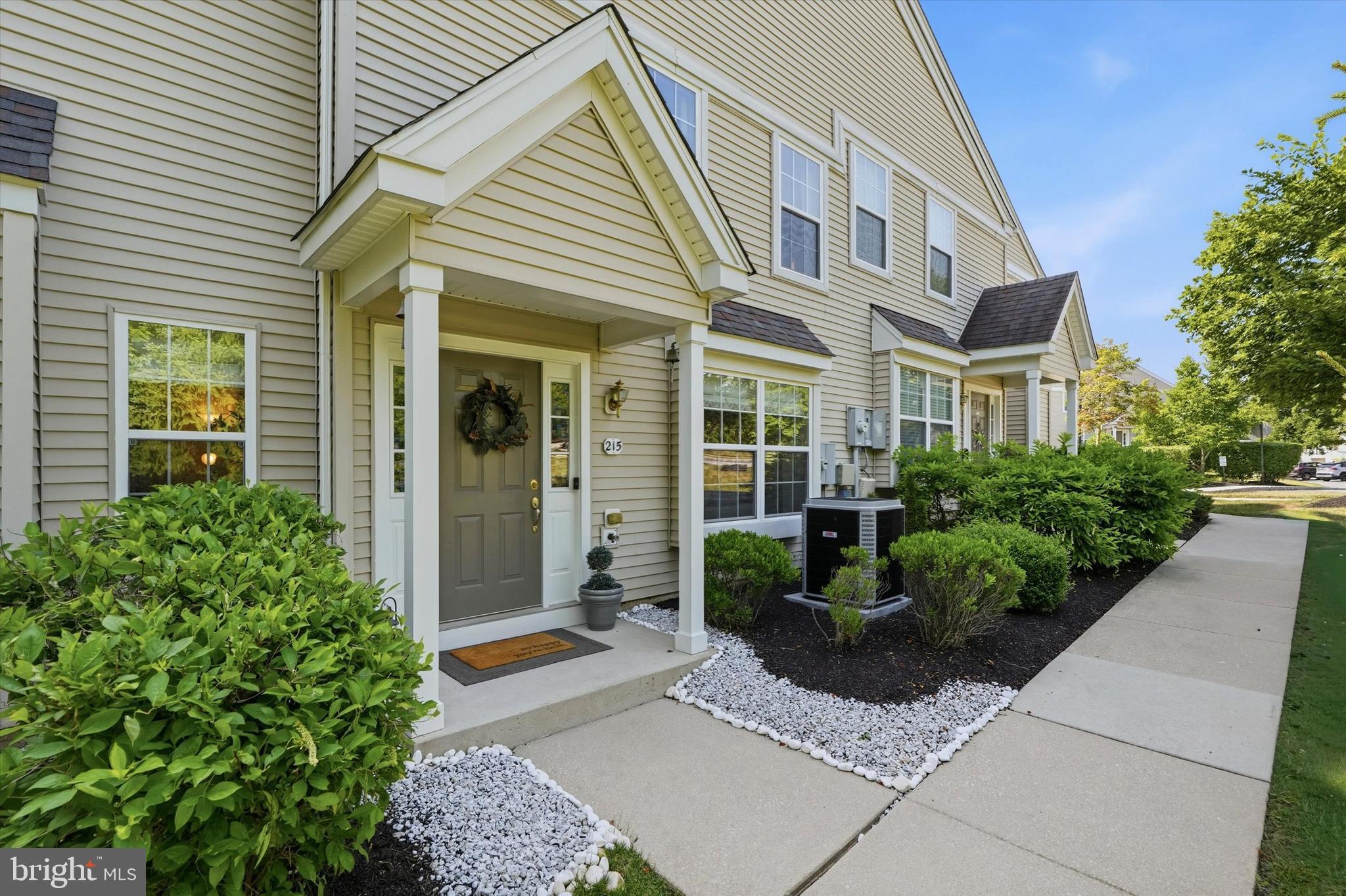 Welcome to 215 Flagstone Road, where privacy, thoughtful updates, and maintenance-free living come together in the highly sought-after Byers Station community of Chester Springs. Perfectly positioned as an end-unit townhome backing up to a peaceful wooded setting, this beautifully maintained home offers three bedrooms, two and a half bathrooms and the convenience of one of Chester County's most desirable neighborhoods.
Providing wonderful natural light from its end-unit location, the home welcomes you with an open-flow floor plan designed for both everyday living and entertaining. The main level has been tastefully updated with COREtec luxury vinyl plank flooring throughout, creating a seamless look that's complemented by neutral paint colors, crown molding, recessed lighting, and a gas fireplace that serves as the focal point of the living room.
The kitchen opens to the living space and features 42-inch cabinetry, stainless steel appliances, a stylish backsplash, recessed lighting, and a movable center island (included with the sale) that provides additional prep space and flexibility. The main floor also features an open concept living room and dining room as well as a convenient powder room and multiple storage closets. Off the kitchen, sliding glass doors lead to a patio overlooking a private yard, manicured flower beds, and mature trees.
Upstairs you’ll find three spacious bedrooms and two full bathrooms. The primary suite is a true retreat, featuring a tray ceiling, a generous walk-in closet, an additional linen closet, and a well-appointed en-suite bath complete with a corner soaking tub and separate tiled shower. Two additional bedrooms share a full hall bathroom, while pull-down attic access provides additional storage needs.
Additional updates include a new HVAC system and furnace installed in 2025, newer hot water heater (2020), remodeled staircase (2020), and a patio upgrade (2024) offering comfort and peace of mind for years to come.
The home includes two assigned parking spaces along with ample overflow parking for guests and visitors.
Life at Byers Station offers a truly low-maintenance lifestyle. The HOA handles exterior maintenance including the roof, siding, gutters, lawn care, snow removal, mulch, and common area maintenance, allowing you to spend your weekends enjoying everything the community has to offer. Residents enjoy access to two swimming pools, two clubhouses, fitness centers, tennis courts, playgrounds, scenic walking trails, and year-round community events, creating a true neighborhood atmosphere.
Located within the award-winning Downingtown East School District and STEM Academy, this exceptional home is also just minutes from the PA Turnpike, Route 100, SEPTA rail service, shopping, dining, and outdoor recreation at Marsh Creek State Park, offering the perfect balance of convenience and idyllic Chester County countryside. Schedule your showing today!
