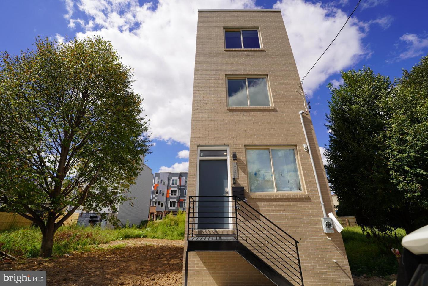 Beautifully designed 3-story home featuring 3 bedrooms and 3 full bathrooms, located in the heart of Norris Square. Step into an open-concept living and dining area accented by a modern built-in electric fireplace and a striking granite brick accent wall with matching mantle. The kitchen boasts white shaker cabinets with elegant gold hardware, an island with pendant lighting and seating for two, and a full stainless steel appliance package. Through the rear door, enjoy access to a private backyard—perfect for outdoor relaxation or entertaining.

The fully finished basement includes a full bathroom with a walk-in shower and a single storage vanity, making it an ideal space for a home office, den, or additional bedroom.

On the second floor, you’ll find two spacious bedrooms, a stacked washer and dryer closet, and a shared hall bath featuring a gray single vanity and a tub/shower combo. The third-floor primary suite offers two generous closets, a frameless walk-in shower, a dual white vanity with ample storage, and a large linen closet.

Just outside the primary suite, you'll find a convenient wet bar with a mini fridge, perfectly positioned for easy access to the rooftop deck—ideal for entertaining or relaxing with sunset views.

Located just a short walk from Riverwards Produce Market and the vibrant dining scenes along 2nd Street, Front Street, and Frankford Avenue. Easy access to public transportation via the Market-Frankford Line.