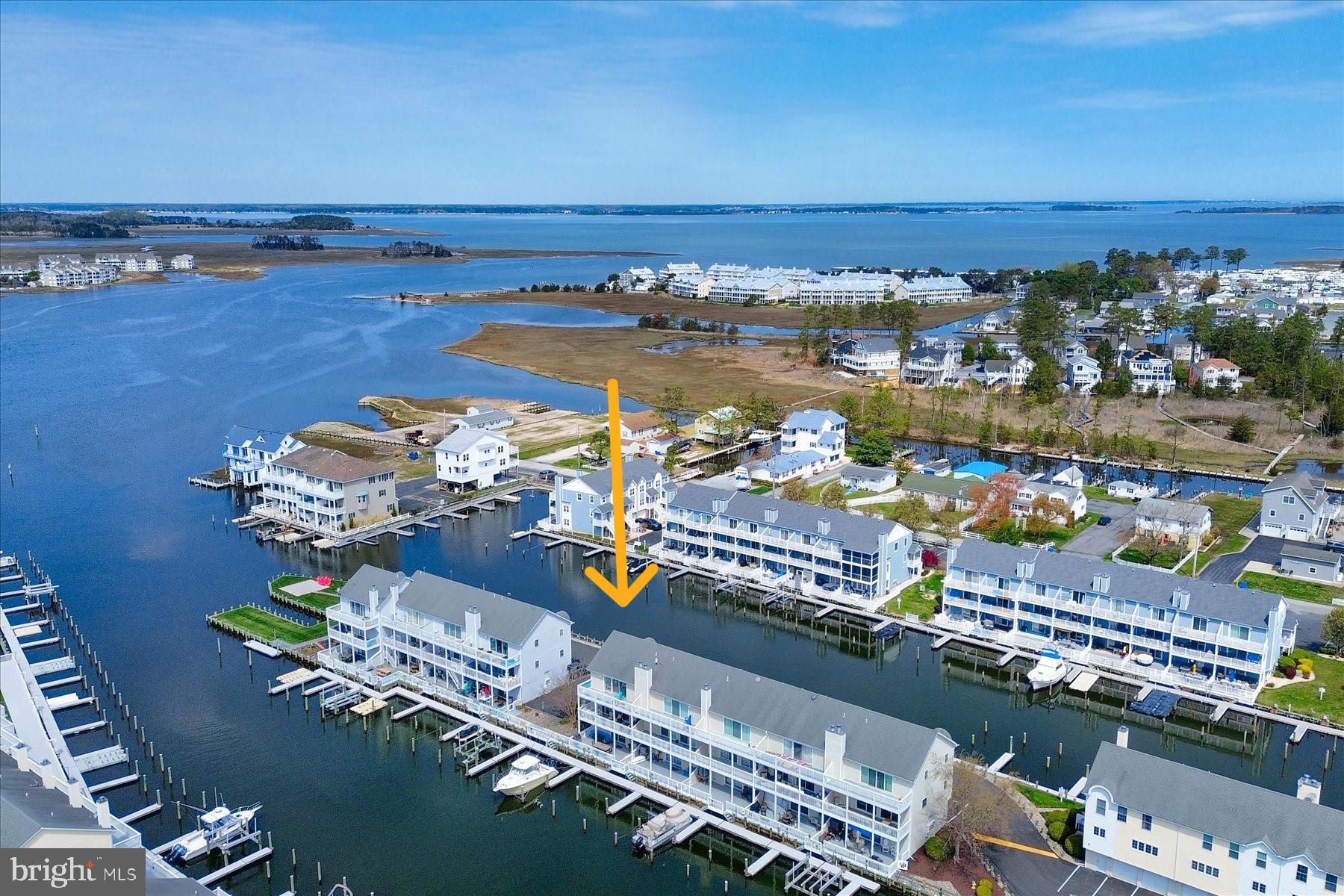Turnkey Waterfront Living Awaits!  Welcome to this beautifully appointed and furnished 4-bedroom, 3.5-bath end-unit townhome located in the sought-after boating community of Bethany Marina, where coastal charm meets modern convenience. With a deeded boat slip (#114) offering direct access to the Indian River Bay, this is the perfect retreat for boating enthusiasts and nature lovers alike.  Step inside to find a spacious, open-concept main level featuring a gourmet kitchen with a large center island, granite countertops, stainless steel appliances including an induction cooktop, and plenty of room for entertaining. The adjacent great room with fireplace flows seamlessly to the covered rear deck, offering picturesque water views—ideal for morning coffee or sunset cocktails.  The first floor hosts a private bedroom suite complete with a full bath and access to a lower-level deck, perfectly set up with a poly picnic table just waiting for your next BBQ or crab feast.  Upstairs, the owner’s suite also has gorgeous water views, a walk-in closet, and an en suite bath featuring a dual vanity and walk-in shower. Step out onto the private upper-level balcony to enjoy stunning sunsets, spot passing boats, or simply listen to the peaceful call of the seabirds.  Two additional guest bedrooms and a spacious shared guest bath complete the top level, providing plenty of space for family and friends. The garage has been thoughtfully converted into a versatile storage area, complete with an extra refrigerator and freezer.  Enjoy community amenities including a sparkling pool and waterfront gathering areas, perfect for socializing with neighbors and friends. Just a short drive or boat ride away from beaches, nature preserves, local shopping, entertainment, and top-tier dining—this home is your launchpad for the best of coastal living!