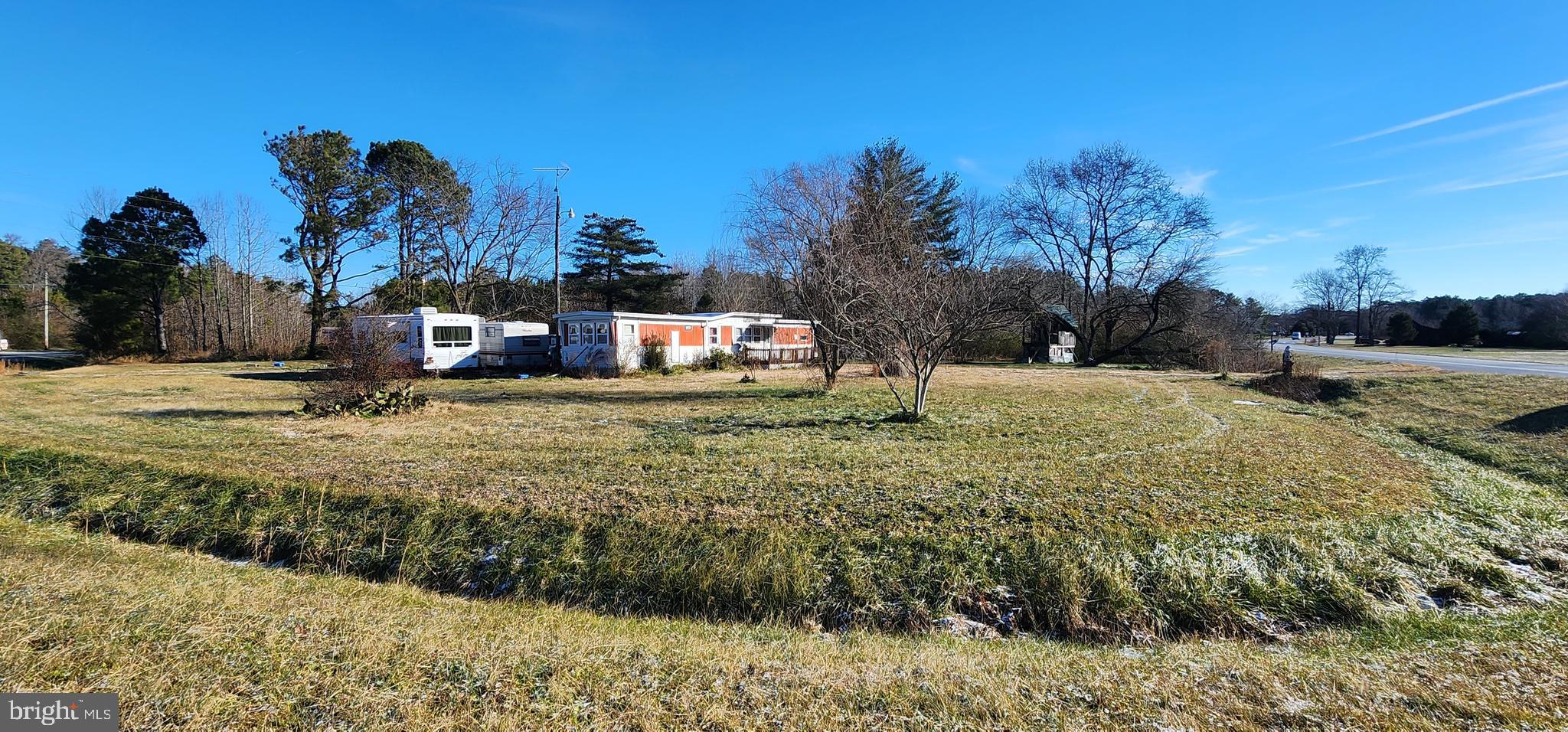 This large 1 acre parcel would make a great site for your dream home. Situated on the corner of Klej Grange and Stockton Roads, this lot offers great privacy with limited neighbors. There is an old mobile home on the property that you could renovate, replace or remove and build a new home. The property already has a well and septic in place and is under 6 miles to downtown Pocomoke City, 11 miles to Snow Hill, MD, 24 miles to Chincoteague Island, VA and 35 miles to Ocean City, MD.