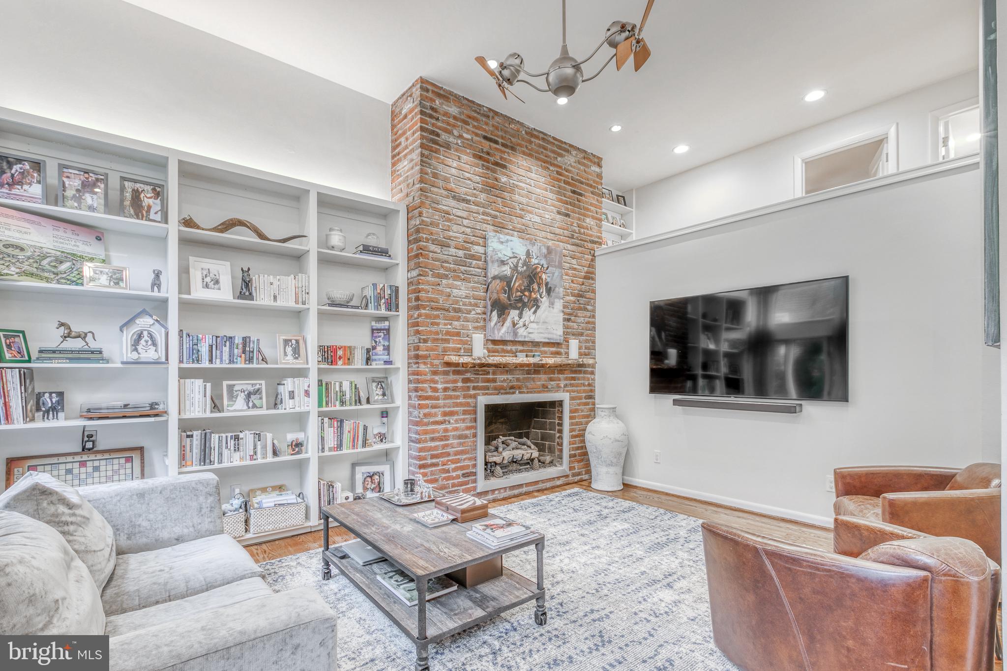 Welcome to 2415 Delancey Place! This 3 bedroom townhouse with PARKING in the heart of Fitler Square has 2 private outdoor spaces plus a private garage, all on a quaint street just off of the Schuylkill River Park. Enter into a foyer with a large coat closet and step down into the newly upgraded eat-in kitchen. The cook's kitchen has ample cabinet storage, a center island for prepping and serving, quartz countertops and backsplash, Wolf wall-oven & stove with vented hood, Sub-Zero refrigerator, built-in microwave, Bosch dishwasher plus an under-counter wine refrigerator. The kitchen is open to a spacious dining area with glass sliders out to the private patio with plenty of space for grilling & outdoor dining. Also on this level is a conveniently located powder room. The second level is a fabulous double-height living room with oversized windows that allow for plenty of natural light. This sizable living area is perfect for retreating at night or for larger gatherings and features a gas fireplace with a custom "live edge" wood mantle plus custom built-ins & shelving. The 3rd floor includes the 2nd bedroom with a large outfitted closet plus an adjacent hall bathroom with a stone-top single vanity and large soaking tub/shower combo. The 4th level is comprised of the master bedroom & bathroom and 3rd bedroom/den. The master suite is generous and includes a walk-in closet. The adjacent bathroom includes a marble-top double-vanity plus a glass-enclosed shower with stone tile-surround. The 3rd bedroom/den with custom closet is currently being used as a nursery though it would also be a perfect home office or gym and features corner windows over-looking charming Delancey Place. The cherry-on-top of this wonderful property is the stunning roof deck with 360-degree views of the city and highlights that include an irrigation system, custom railings with lighting, refrigerator, & an outdoor TV with cable. This property also features a lower level laundry room with storage, hardwood flooring throughout, "smart home" upgrades such as the Nest thermostat, Frontpoint security system with cameras & keyless entry. This location neighbors the green spaces, tennis courts, playground, dog park & running/walking/biking trails of the Schuylkill Park and is within blocks of local restaurants, coffee shop, and city conveniences and a short commute to CHOP, Penn, Drexel, 30th Street Station and Rittenhouse Square.