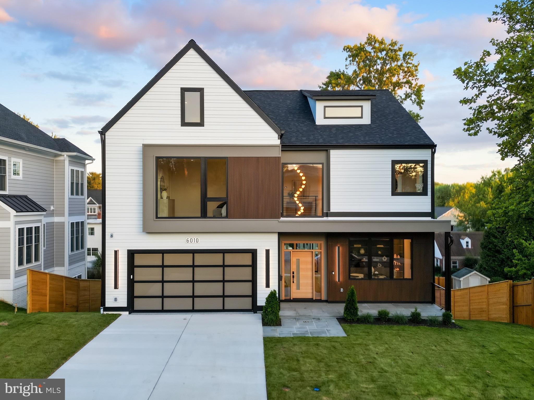 Designed with an unwavering commitment to craftsmanship, timeless materials, and intentional design, this extraordinary custom residence redefines modern organic living.

Offering over 7,000 square feet across four finished levels, this exceptional residence features 7 bedrooms, 5 full bathrooms, and 1 powder room, thoughtfully designed for both sophisticated entertaining and comfortable everyday living.

Beyond the impressive white oak pivot entry door, a dramatic two-story foyer creates an unforgettable first impression, introducing the home’s warm modern organic aesthetic through a hand-selected Sherwin-Williams Alabaster palette, wide-plank white oak flooring, bespoke alabaster lighting, and clean architectural lines. Just off the foyer, a private study showcases custom walnut built-ins with integrated lighting, creating an elegant and functional workspace.

Designed to maximize natural light and seamless sightlines, the main level flows effortlessly from one beautifully curated space to the next. The great room features soaring 10-foot ceilings, expansive floor-to-ceiling windows, and a dramatic floor-to-ceiling travertine fireplace. Expansive sliding glass doors open to an oversized covered deck, creating a seamless indoor-outdoor living experience.

At the heart of the home, the chef’s kitchen is centered around a breathtaking Taj Mahal quartzite waterfall island, while leathered and polished Taj Mahal quartzite continues throughout the perimeter countertops, backsplash, and custom hood surround. Furniture-quality walnut detailing, custom cabinetry, bespoke alabaster lighting, an expansive walk-in pantry, and a premium Thermador appliance suite—including a 48-inch Thermador Freedom built-in refrigerator and professional 48-inch gas range with double ovens—create a kitchen where exceptional design and everyday functionality exist in perfect harmony.

Framed by dramatic floor-to-ceiling windows and illuminated by a sculptural alabaster chandelier, the dining room provides an elegant setting for intimate dinners and grand entertaining. Adjacent, a custom beverage station with illuminated floating shelves, Taj Mahal quartzite, custom cabinetry, and a built-in wine refrigerator enhances the home’s effortless approach to entertaining.

A thoughtfully designed mudroom and an oversized laundry room featuring custom cabinetry, built-in storage, a dedicated wash station, generous workspace, and a wine cooler continue the home’s exceptional attention to detail.

The private primary suite offers expansive walk-in closets, a private balcony overlooking the backyard, and a spa-inspired bath designed in the same timeless palette of natural materials found throughout the home.

The fully finished lower level offers a spacious recreation room, fitness area, guest suite, kitchenette, and abundant storage, providing exceptional flexibility for entertaining, multigenerational living, or extended stays.

Ideally located in Bethesda with convenient access to downtown Bethesda, premier shopping and dining, neighborhood parks, NIH, Walter Reed, major commuter routes, and highly regarded schools.

Created for those who appreciate exceptional design and enduring craftsmanship, this is more than a home—it is a carefully composed residence where architecture, natural materials, and thoughtful restraint create a timeless expression of modern organic living.