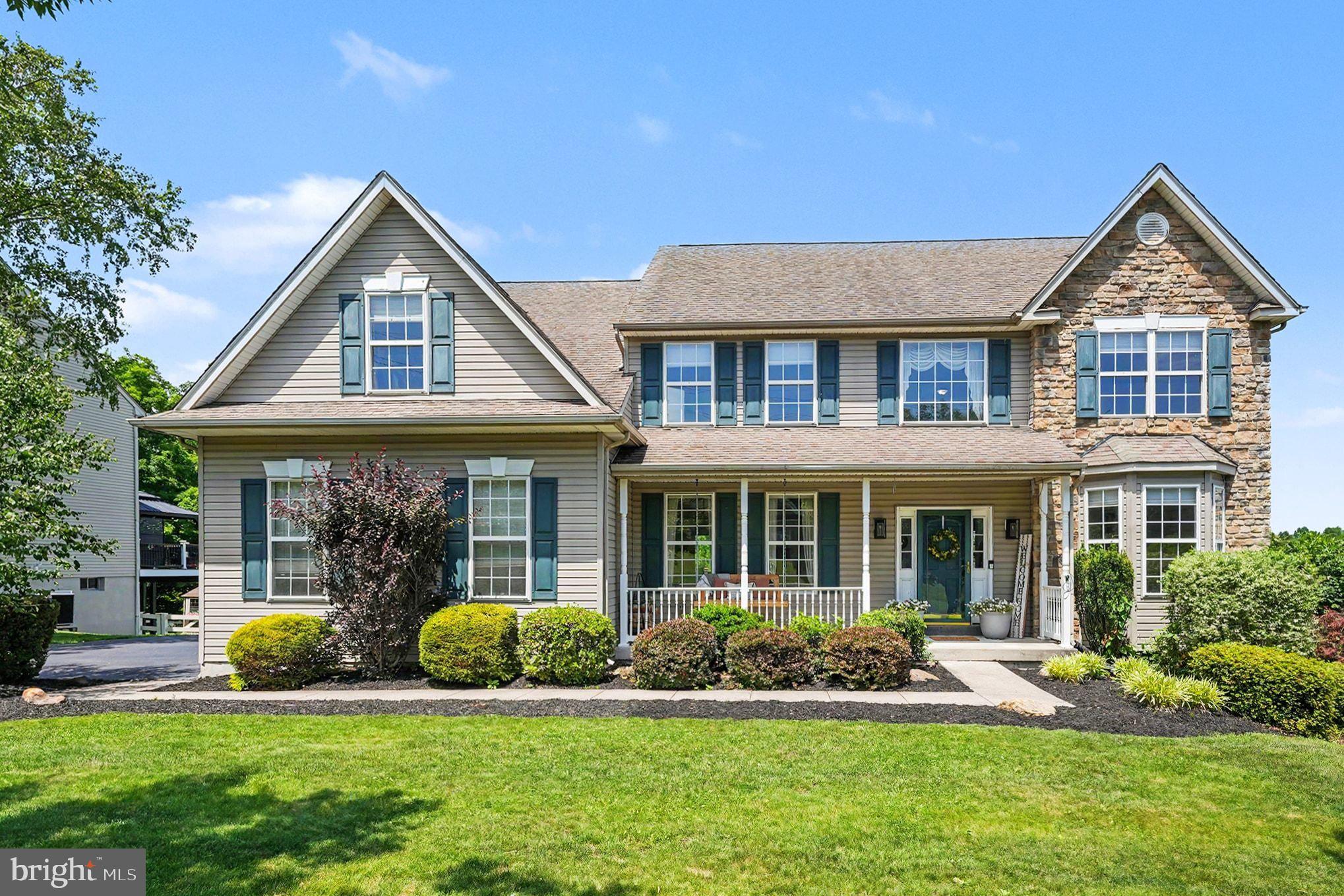 Showings Begin Friday at 4PM. From the moment you step onto the inviting covered front porch and enter the grand center-hall hardwood foyer, this exceptional home guides you through a perfectly designed layout. To one side sits a sun-drenched formal living room (or flex room- currently set up as a play room), while the other reveals an elegant dining room dressed in classic crown molding and raised-panel wainscoting. The heart of the home unfolds into a gourmet eat-in kitchen, beautifully appointed with 42" cabinets, a built-in desk, a generous pantry, and striking granite countertops paired with a stone backsplash. This culinary space flows seamlessly into a dramatic family room, where soaring cathedral ceilings and a cozy gas fireplace create a warm, striking centerpiece. Tucked just off the family area, a private home office behind classic French doors provides the ideal quiet workspace, while a discrete main-floor laundry room with a utility sink and a guest powder room add ultimate everyday convenience.
Ascend the dual-entry staircase to find a wide hallway overlooking the main level, leading to a sprawling owner's suite characterized by high cathedral ceilings, a private sitting area, an expansive walk-in closet, and a spa-like en-suite bath with dual sinks, a soaking tub, and a separate shower. Three additional generously sized bedrooms with ample closet space share a well-appointed full hall bath on this level. Downstairs, the fully finished basement transforms into an entertainer’s paradise, anchoring around a custom, handcrafted wet bar with mirrored shelving and six-stool seating, alongside dedicated zones for gaming, media viewing, a half bath, a craftsman's workshop, and a separate storage room.
The backyard is a private summer oasis, featuring a 20x12 composite deck off the kitchen that steps down to a 12x20 paver patio and a pristine, 16x32 inground pool wrapped in a fully fenced yard. Complete with a storage shed, and a two-car garage, this property offers incredible perks with zero HOA fees, Bella Vista Golf Course discount and a prime location just minutes from Manderach Park’s sports courts and trails. This is the perfect place to call home-schedule your private tour today!