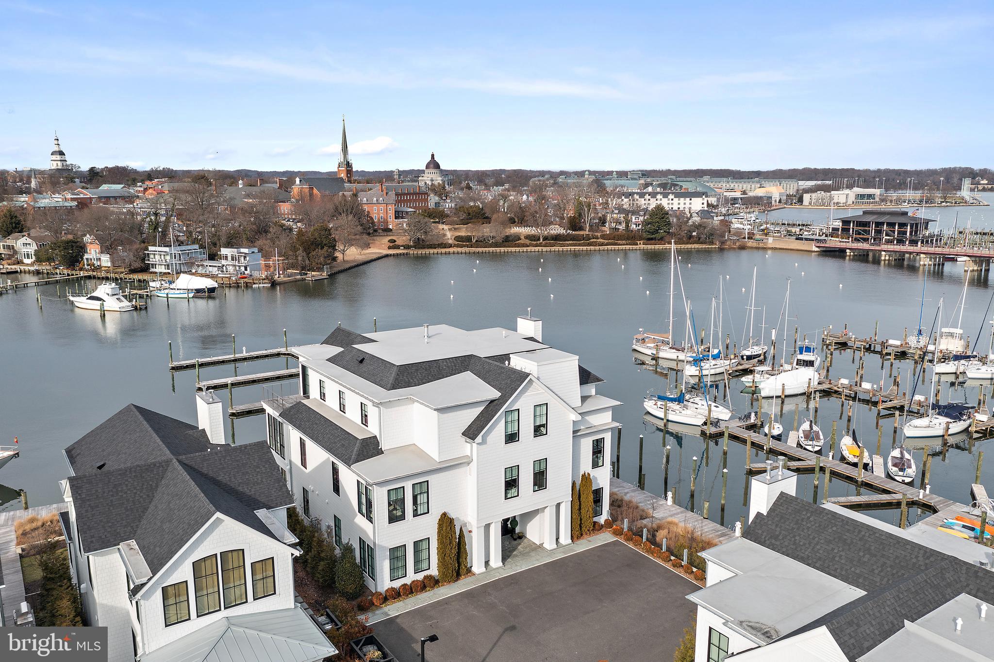 South Annapolis Yacht Center is located on Spa Creek overlooking the beautiful skyline of Historic Annapolis. This award winning residence features an elegant interior design that brings the feel of the adjoining waterway into the living area. Patrick Sutton thoughtfully did the interior design and Bret Anderson of Pyramid Builders constructed this magical 3 bedroom, 3 bath waterfront residence. A bright open floor plan, perfect for entertaining, connects to the wrap around deck overlooking the water. The kitchen features a six burner La Cornue range with matching hood, Sub-Zero refrigerator with custom freezer draws, wine cooler and a large luxe marble center island all overlooking the water. The Primary Suite enjoys beautiful views of Spa Creek & Annapolis, a large dressing room with rosewood cabinets and a luxurious spa like bath. The Primary suite walls are fully upholstered with a wool herringbone material and braided leather trim giving the space a warm comfortable feel. There are 2 additional ensuite bedrooms with one doubling as a den/in home office. There are 2 gas fireplaces, one in the main living area and one on the waterfront deck. There is a rented 1 car garage (across the street, $700/mo) and a storage unit in the lower level of the building. Access to this fabulous residence is via an elevator that opens directly into the unit. Enjoy watching the Christmas Boat Parade, Commissioning Week Blue Angels Show and the 4th of July Fireworks from the waterfront deck. The adjoining world class marina not only is a perfect spot to keep your boat but a great view to watch some of the most beautiful yachts on the East Coast. The prime Spa Creek location, the quality of construction and the award winning interior design puts this property in a league of its own.