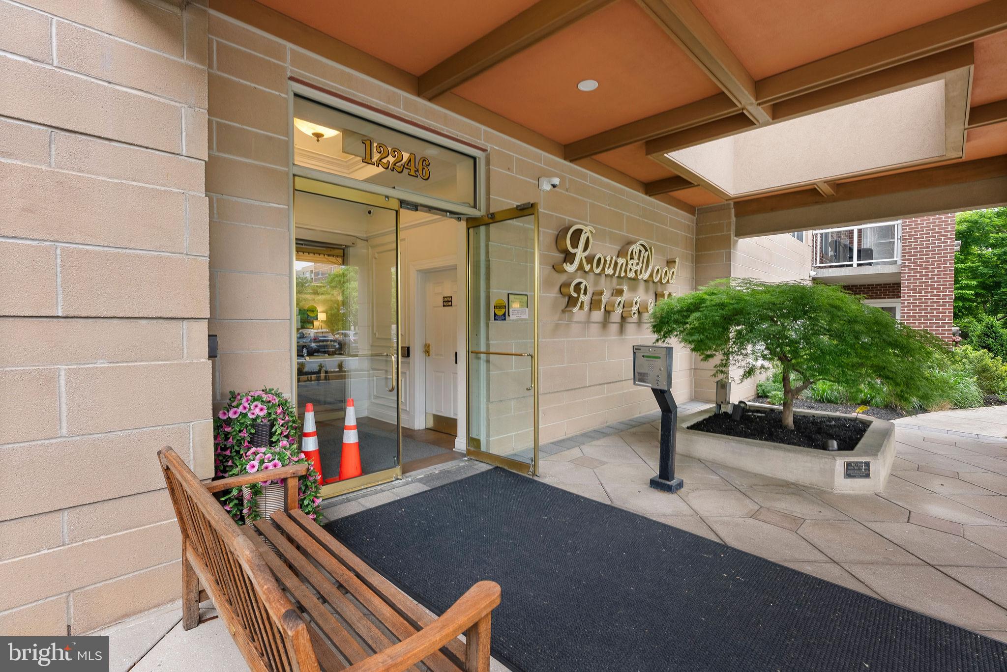 This beautiful 2-bedroom, 2-bathroom condo is located in the highly sought-after community of Roundwood Ridge in Mays Chapel North. From the moment you enter the welcoming foyer, you’ll notice the beautiful hardwood floors that flow throughout the living and dining rooms. The dining room also features custom built-in shelves that provide fantastic storage while also offering the perfect place to display your favorite collectibles. The sun-filled kitchen offers plenty of cabinet space, granite countertops, stainless steel appliances, gas cooking, and a cozy breakfast/sitting area with a gas fireplace. Step outside and enjoy your morning coffee on the covered balcony overlooking the peaceful wooded setting. The spacious primary suite features a large walk-in closet and an ensuite bathroom with an updated double sink vanity and walk-in shower. The second bedroom and hall bathroom are both generously sized. This unit also offers fantastic closet space throughout, plus an additional storage cage conveniently located on the same floor. Natural light and neutral décor make this home feel warm, inviting, and move-in ready. Roundwood II has recently undergone impressive updates, including a beautifully renovated entrance foyer, updated hallway décor throughout the building, and a stunning Party Room with a kitchenette available for residents to enjoy. Conveniently located within walking distance to Graul’s Market, Kooper’s North, a hair salon, and other everyday shops and restaurants, this location offers easy, low-maintenance living in the heart of Mays Chapel North.