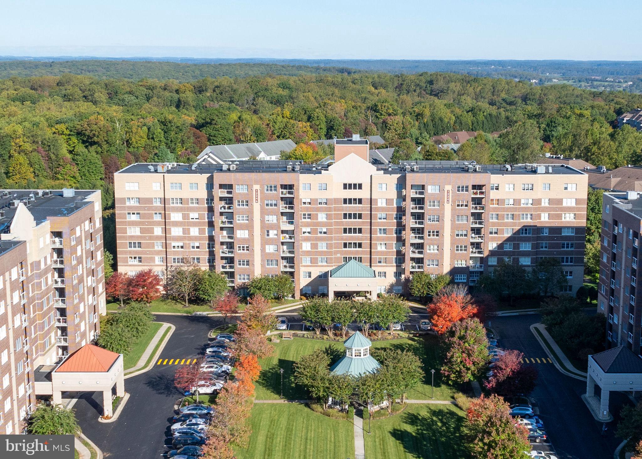 This beautiful 2-bedroom, 2-bathroom condo is located in the highly sought-after community of Roundwood Ridge in Mays Chapel North. From the moment you enter the welcoming foyer, you’ll notice the beautiful hardwood floors that flow throughout the living and dining rooms. The dining room also features custom built-in shelves that provide fantastic storage while also offering the perfect place to display your favorite collectibles. The sun-filled kitchen offers plenty of cabinet space, granite countertops, stainless steel appliances, gas cooking, and a cozy breakfast/sitting area with a gas fireplace. Step outside and enjoy your morning coffee on the covered balcony overlooking the peaceful wooded setting. The spacious primary suite features a large walk-in closet and an ensuite bathroom with an updated double sink vanity and walk-in shower. The second bedroom and hall bathroom are both generously sized. This unit also offers fantastic closet space throughout, plus an additional storage cage conveniently located on the same floor. Natural light and neutral décor make this home feel warm, inviting, and move-in ready. Roundwood II has recently undergone impressive updates, including a beautifully renovated entrance foyer, updated hallway décor throughout the building, and a stunning Party Room with a kitchenette available for residents to enjoy. Conveniently located within walking distance to Graul’s Market, Kooper’s North, a hair salon, and other everyday shops and restaurants, this location offers easy, low-maintenance living in the heart of Mays Chapel North.