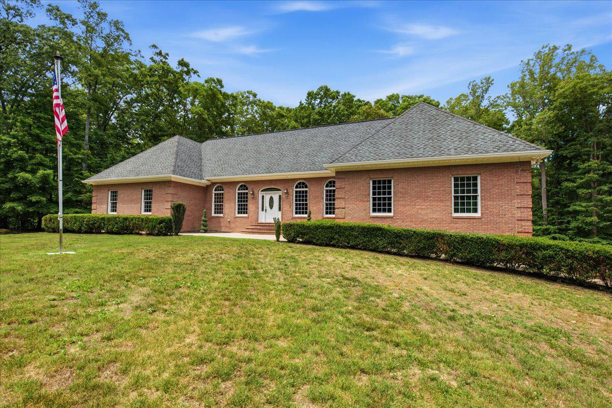 PRICE IMPROVED! SHOP AND RESIDENCE on 18+ ACRES. All brick rambler on 18.64 acres of wooded, private land offering exceptional craftsmanship and versatility.  Geothermal heat pumps and Andersen windows, extensive power supply specs are just a couple of the steps taken by the owner to make this a long-lasting home. Three-bay garage and shop space in the lower level of the home AND a large shop building, separately located on the acreage for home privacy.  The 4-bedroom, 4.5-bath brick residence features a massive central great room with vaulted ceilings and a striking masonry fireplace with custom wood elevator.  The adjacent gourmet kitchen is designed for both function and style, featuring stainless steel appliances, custom backsplash, and a huge center island. The large main level owner's suite is large in scale with huge closet and bath. Owner's shower has body sprays, corner tub is jetted! This suite also enjoys access to the rear patio. Two more large bedrooms share a second full bath, and the laundry room is on this main level as well. The entire floor plan is perfect for large gatherings, making lasting memories, holiday events. The finished basement includes a small in-law apartment, mechanical room and storage, room for a large recreation room. Outdoor living areas are equally impressive, with two levels of poured concrete patios, including a built-in grill station off of the kitchen. Car enthusiasts and hobbyists will appreciate the two garages within the home, totaling 5 bays. Lower level garage has another full bath, room for multiple vehicles and shop area, perfect for collectors and mechanics. SHOP BUILDING- a 55 x 60  shop with 14 x 40 lean-to, other various outbuildings for storage various tools and equipment conveyances, offering endless possibilities. Multiple uses with motor lifts, plasma table, air hoist on steel beam from front to back of the main space. The property is conveniently accessible to Route 5 and Route 235, offering easy access to shopping, dining, and commuter routes. SOLD AS IS.