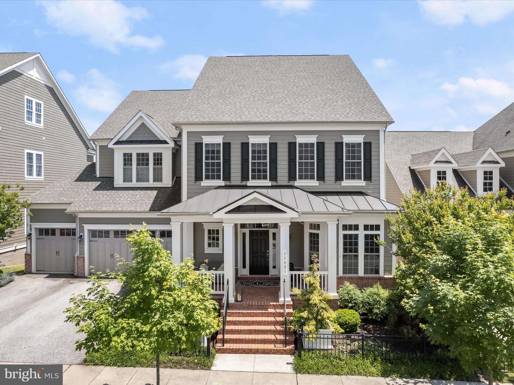 Welcome home to 11421 Dairy Street located in Howard County’s finest community; Maple Lawn. This is a premiere Maple Lawn offering in the most prime neighborhood location and boasts a whopping 9,167 total square feet of lavish living space. Not only is this one of the largest homes in Maple Lawn, but this Garden District stunner features a rarely available MAIN LEVEL BEDROOM SUITE and a coveted 3-car garage. Built by the award-winning Williamsburg Homes, this Hawthorne model has every upgrade imaginable and the jaw-dropping kitchen is worthy of a magazine. The custom stone paver patio, TREX deck, fire pit and water features in the expansive yard back to conservation area and provide unparalleled privacy and outdoor entertaining space.  

The wow factor on the main level immediately impresses with an open-concept foyer featuring soaring 20’ ceilings. There’s a private office located in the front of the home and both the formal living and dining rooms present coffered ceilings. The family room couldn’t be any more inviting or on-trend with its gas fireplace, floating shelves and designer statement wall. The best-in-class chef’s kitchen features grey shaker-style cabinetry, white quartz countertops, 6-burner Wolf range, separate wall oven, Sub-Zero fridge and a beautifully functional farm sink. The mudroom and family welcome center is complete with built-ins which provide the perfect drop-zone upon entering the home. And what truly sets this home apart is the luxe primary bedroom suite also located on the main level, truly making this home one of the crown jewels of the community.

A second primary bedroom suite awaits on the upper level featuring tray ceilings, recessed lighting, a sitting room and two walk-in closets with organizers. The upstairs primary bathroom boasts split vanities with quartz countertops, a garden tub, and a huge shower stall with multiple shower heads. There are two additional secondary bedrooms upstairs which share a bathroom. And the sprawling guest bedroom suite with its own large walk-in closet and full bathroom as well as the laundry room are also located on the upper level. The lower level is in essence a home all its own with its spacious living room, wet bar with full size fridge, separate wine fridge, sink, dishwasher and large eating island. A custom theater room, home gym and full bathroom are also located on the lower level as well as two unfinished rooms for storage or future customization. 

This flagship residence serves as a benchmark of the refined luxury, quality construction, style and taste that’s become synonymous with Howard County’s finest community. Zoned for highly rated Howard County Schools, conveniently located close to all major Baltimore/DC commuter routes, and with enviable amenities including a resort-style community pool, tennis courts, pickleball courts, basketball courts, state-of-the-art gym and more, you’ll quickly see why Maple Lawn is one of the most sought-after communities in the region and why 11421 Dairy Street is truly one of its finest properties.