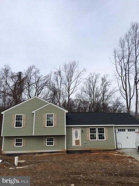 New split level home with 3 BR, 2 1/2 BA, master bathroom, open floor plan for kitchen and living room.  Lower level finished with large family room and 1/2 bath.  Full basement for storage.  One car garage. Half acre lot.  Close to MD line right outside Emmitsburg. Construction almost complete. Don't miss out, take a look!