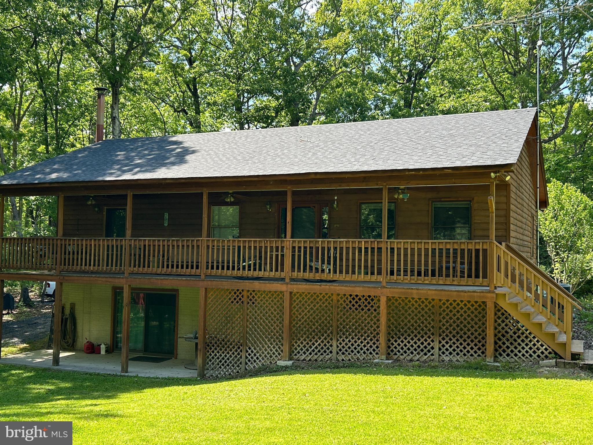 PRICE CORRECTION! Experience the best of country living at your 4th of July staycation. Your dream retreat situated in the heart of nature; whether you seek a vacation getaway or a permanent paradise, this property is your perfect match! Charming cedar ranch offers 2+ acres of land, framed by the Blue Ridge Mountains and Shenandoah River, creating the perfect escape. New roof, New well, Newly graveled driveway and freshly painted interior make this home ready to move in and enjoy. Flat yard for all your family gatherings or a nice evening fire after a day of kayaking and fishing. Huge primary bedroom with private bath, nice sized closet and access to porch. Kitchen has plenty of cabinet space and natural light. Beautiful hardwood floors. Fabulous porch running the full length of the home is excellent for that morning coffee or relaxing with a good book. Separate mud/laundry room. Full unfinished walk-out basement with woodstove and a secure locking storage room.  New heat pump installed 2021. Roof 12/25 Well 2/26 **Priced well below tax assessment!** Convenient commuter location and about a mile from the public Shenandoah River access point. Close to National and State Parks, Skyline Drive and the Appalachian Trail – Perfect for Hiking, Wildlife & Endless Outdoor Adventures.