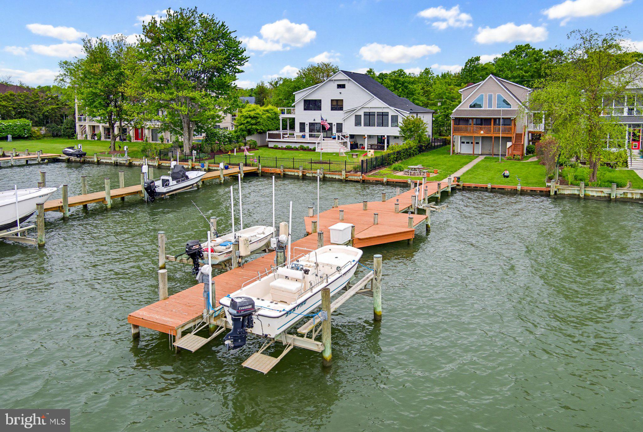 PRICE  REDUCED AGAIN for quick sale!!!!!Beautiful views of Selby bay and the South river from this lovely Waterfront home!! Offers a private pier with two boat lifts(left is 12,500 lbs right is 8,500 lbs) and jet ski lift(AS IS)! 2-3 car garage under upper floors(with garage door on waterside of house. Great screened porch across rear overlooking the water.  Built in 2004 Primary bedroom occupies the entire upper floor! Two bedrooms on mail level. Kitchen offers granite  and stainless appliances (and great waterviews). Family room has soaring ceilings and soaring waterviews!! Comunity offers waterfront amenities include picnic area, community center ,private beach, playground, basketball/pickle ball court, and a boat ramp!!Community is special tax benifit community (Fees collected in tax bill by County). Please note square footage of the house shown in Tax records is incorrect.