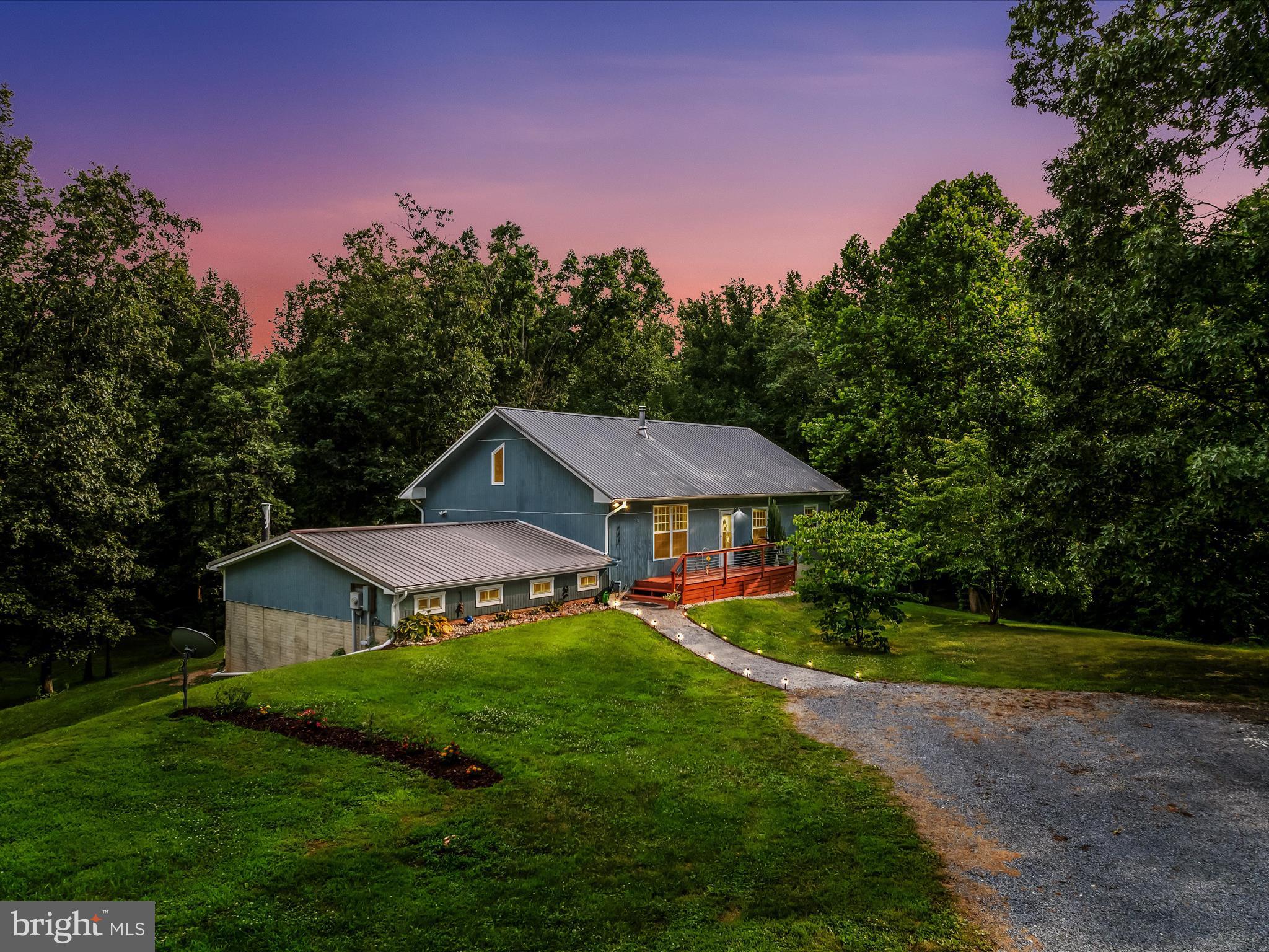 UNRESTRICTED don't miss this 4-bedroom 2.5-bathroom home on 10.7 unrestricted acres in the eastern part of Morgan County. This home has a Hedgesville address but is in Morgan County, not Berkeley County. Home has an open floor plan with 3 bedrooms & 2 bathrooms on the main floor, a loft bedroom and two additional rooms in basement that can be two additional bedrooms to give you six bedrooms if needed. Basement rooms can also be an office or whatever you choose. Family room area in basement also gives you more area for entertaining. Basement also has a half bath. The 25x25 workshop area with garage door gives you the space for your toys oy lawn equipment. Large rear deck for enjoying a morning beverage or watching the wildlife. There is cleared area for your garden and wooded area to give you privacy. Enough acreage for your recreation (ATV's) and hunting.  Bring your pets or animals and enjoy the freedom of no restrictions.