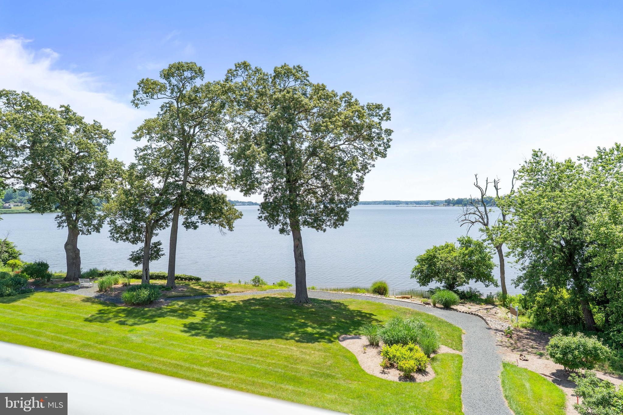 Beautifully updated waterfront end-unit condo offering sweeping water views and a private balcony for relaxed outdoor living. Freshly painted throughout, the light-filled open floor plan features gleaming wood flooring and spacious living and dining areas designed to maximize the stunning waterfront backdrop.
The renovated kitchen offers new cabinetry with plentiful storage, stainless steel appliances, and modern finishes. Additional recent upgrades include new HVAC system and a stacked washer and dryer for added convenience. Private storage room just down the hall. Enjoy low-maintenance living in a well-appointed community offering a clubhouse, fitness center, pool, hot tub, and regular community activities.  Close to shopping, dining, and major commuter routes.