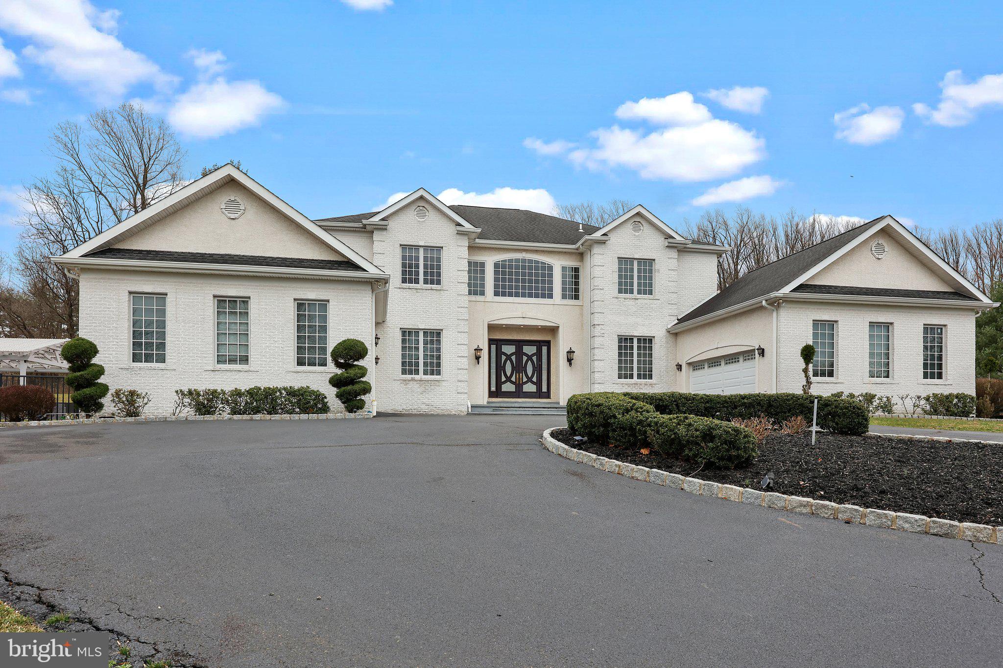 Discover the epitome of luxury living nestled within a private enclave of distinguished properties, harmoniously adjacent to the Pennypack Nature Preserve. Encompassing over 3 acres of lush landscape, this exceptional residence offers an idyllic retreat from the bustling world, without sacrificing convenience.

Upon arrival, be greeted by grand double doors adorned with beveled glass, leading into a breathtaking two-story foyer boasting a limestone floor and a graceful double staircase. Throughout the home, indulge in the finest craftsmanship showcased by extensive crown moldings, custom millwork, and exquisite details such as solid pine doors, gleaming hardwood floors, and striking marble, stone, and granite accents.

Entertain with ease in generously proportioned rooms featuring lofty 10-foot ceilings on the main level, complemented by a state-of-the-art whole house stereo system. Delight guests in the banquet-sized dining room, complete with cherry cabinetry, a fireplace with a fossil limestone surround, and ample space for formal gatherings.

The heart of the home lies in the sunlit great room, boasting a soaring 20-foot ceiling and a magnificent stone fireplace, creating an ideal setting for showcasing art or unwinding with loved ones. Culinary enthusiasts will relish in the designer kitchen, adorned with natural stone floors, Signature custom cabinetry, and high-end stainless steel appliances, including a full 6-burner gas range and double wall oven and walk-in pantry.

Discover an additional haven within this remarkable residence - a primary suite designed to accommodate multi-generational living or guests in unparalleled comfort. Enhanced with hardwood floors and granting direct access to the patio, this space offers unparalleled convenience and privacy. Your personal retreat includes a fully equipped kitchenette with a sink, microwave, and refrigerator, ensuring effortless hospitality. Adjacent, indulge in the attached ensuite featuring a double vanity sink, indulgent Jacuzzi tub, water closet, and dual walk-in closets, providing ample storage and luxurious convenience. With this exquisite addition, this residence seamlessly caters to diverse lifestyle needs while maintaining an ambiance of opulence and tranquility.

Retreat to the luxurious main bedroom suite on the second floor, featuring a cozy gas fireplace, private deck, mini-bar, and two custom walk-in closets. Pamper yourself in the opulent granite bath, complete with a whirlpool tub and oversized steam shower, offering a sanctuary of relaxation.

Designed for ultimate enjoyment, the finished lower level offers approximately 4000 sq. ft. of flexible living space, including a home theater with surround sound, sauna, gym, and bedroom/office, ensuring every desire is catered to. Outside, revel in the secluded summer oasis, featuring a lighted spa, L-shaped pool with lap and diving areas, and expansive patio with outdoor kitchen with built-in fireplace and grill with pergola, perfect for al fresco entertaining.

Complete with attached garage space for four cars and extensive driveway parking, this distinguished residence embodies refined living at its finest, promising a lifestyle of unparalleled luxury and serenity. Welcome home to your private sanctuary amidst nature's embrace.
