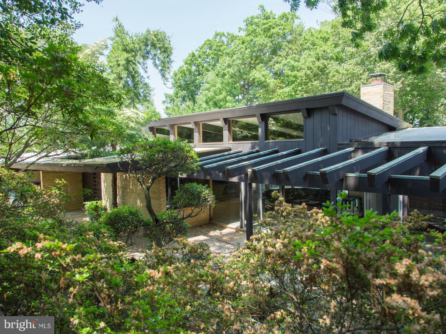 AMAZING PRICE. Fabulous style and flow with possible 1-level living. Incredible architecture and materials Tennessee stone walls, marble, terrazzo,  mahogany doors, special wood paneling, stone fireplace. 5 ensuite bedrooms, master w/sitting & two dressing rooms, sunroom, family room, breakfast room, exercise room, office. Extensive glass brings spectacular outdoors inside.