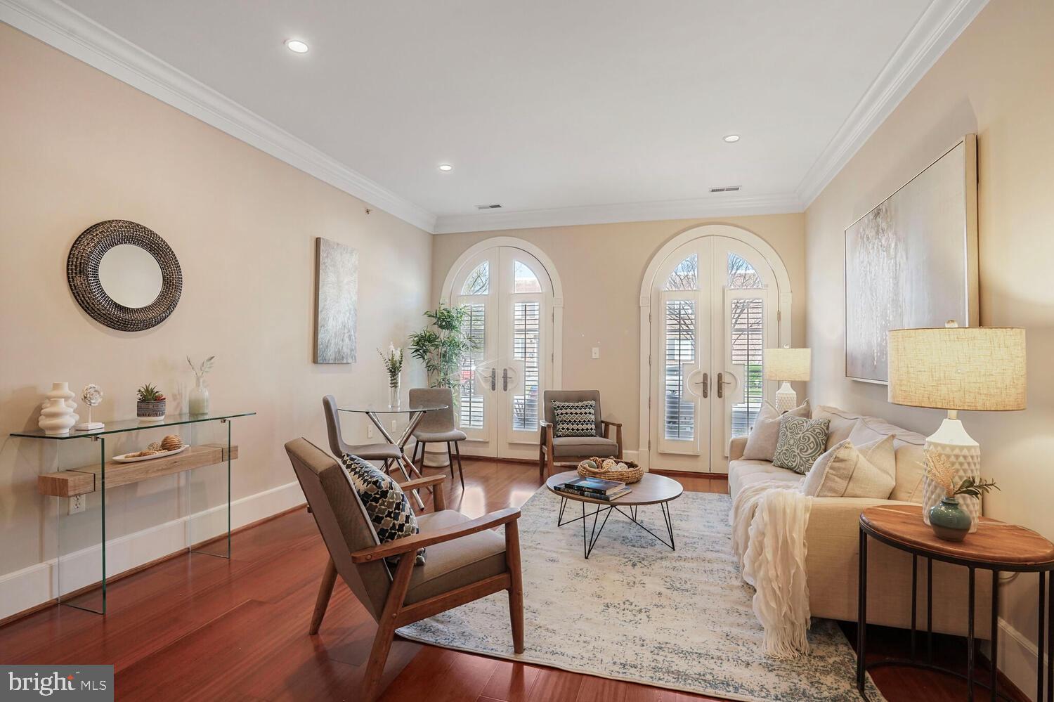 Welcome home to your elegant, sun drenched, and eco-friendly ground floor condo in the heart of Old Town Alexandria. This beautiful 2-bedroom & 2-bathroom corner unit with 9-foot ceilings, crown molding, private patio, and over 1,100sq/ft of interior living space is truly a rare gem. This unit was designed with quality in mind featuring high end stainless-steel KitchenAid appliances with Subzero refrigerator, white subway tile backsplash, black quartz countertops, Brazilian cherry wood flooring, brand new vinyl-plank kitchen floor tiling, brand new carpeting in both bedrooms, oversized windows and a double set of French doors leading out to your private patio all outfitted with custom plantation shutters. Spacious master bedroom with multiple windows, large walk-in closet with custom Elfa shelving, a spa like master bathroom with soaking tub, double sink vanity, and glass shower. Both bathrooms feature Carrara marble tiling. The washing machine and dryer were replaced in March 2021, the geothermal HVAC was replaced in August 2021, and the hot water heater was replaced in July 2024. Unit 106N comes with one dedicated underground parking space, bicycle parking, and a separate garage storage unit. Community amenities include two rooftop terraces, three fitness rooms, and a community lounge. This prime location places you just blocks from Trader Joe’s, Harris Teeter, the Potomac River, the Old Town North Arts and Cultural District, and Braddock Metro. Stroll to top restaurants, charming boutiques, and scenic waterfront trails, all while enjoying quick access to GW Parkway, Reagan National Airport, and Washington, DC.