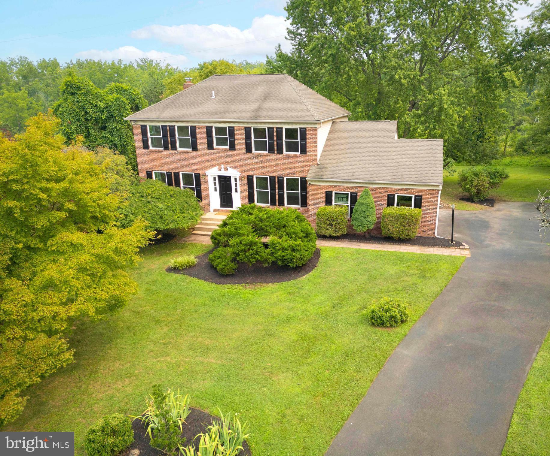 Welcome to 14 Brighton Place, a beautiful brick colonial home in the highly sought after award-winning Council Rock School District. This expansive home offers four bedrooms, three bathrooms and an attached two-car garage all situated on just under a half-acre in the Durham Lea Development. The home is illuminated with natural light and hardwood floors throughout. The main level has plenty of space for daily life and entertainment with a living room that has recessed lighting and large over-sized windows, a full dining room and a family room that has a wood-burning fireplace, separate study or storage nook and sliding glass door to an upper deck. The kitchen is brand new with granite counter tops, recessed lighting, subway tile backsplashes, lazy-susan corner cabinets, and a pantry closet. The breakfast room connects to the two-car garage and offers access to and views of the peaceful backyard, decks and organic raised-bed garden. The backyard has a pastoral view and abuts the Clark Nature Center. The main floor is complete with a laundry and powder room. All four bedrooms are all on the second floor with two newly renovated bathrooms: one off the hall with generous mirrored medicine cabinets, a linen closet, a new double vanity sink that includes drawers with charging outlets and a high-end bathtub. The other all-new bathroom, with a walk-in tiled shower, is en suite in the spacious primary bedroom that has a connected space perfect as a dressing room, library, office or sitting area. The lower level is partially finished, with recessed lighting and offers space for an additional family area/playroom, gym or office. Conveniently located to Newtown Borough, Durham Lea connects directly to Newtown Township’s walking course and ballfields, is immediately adjacent to Tyler State Park and its hiking and biking trails, Bucks County Community College (less than a ½ mile walk), the Village shops, two supermarkets within walking distance and lots of great restaurants. Everything is at your fingertips from 14 Brighton Place's prime location.