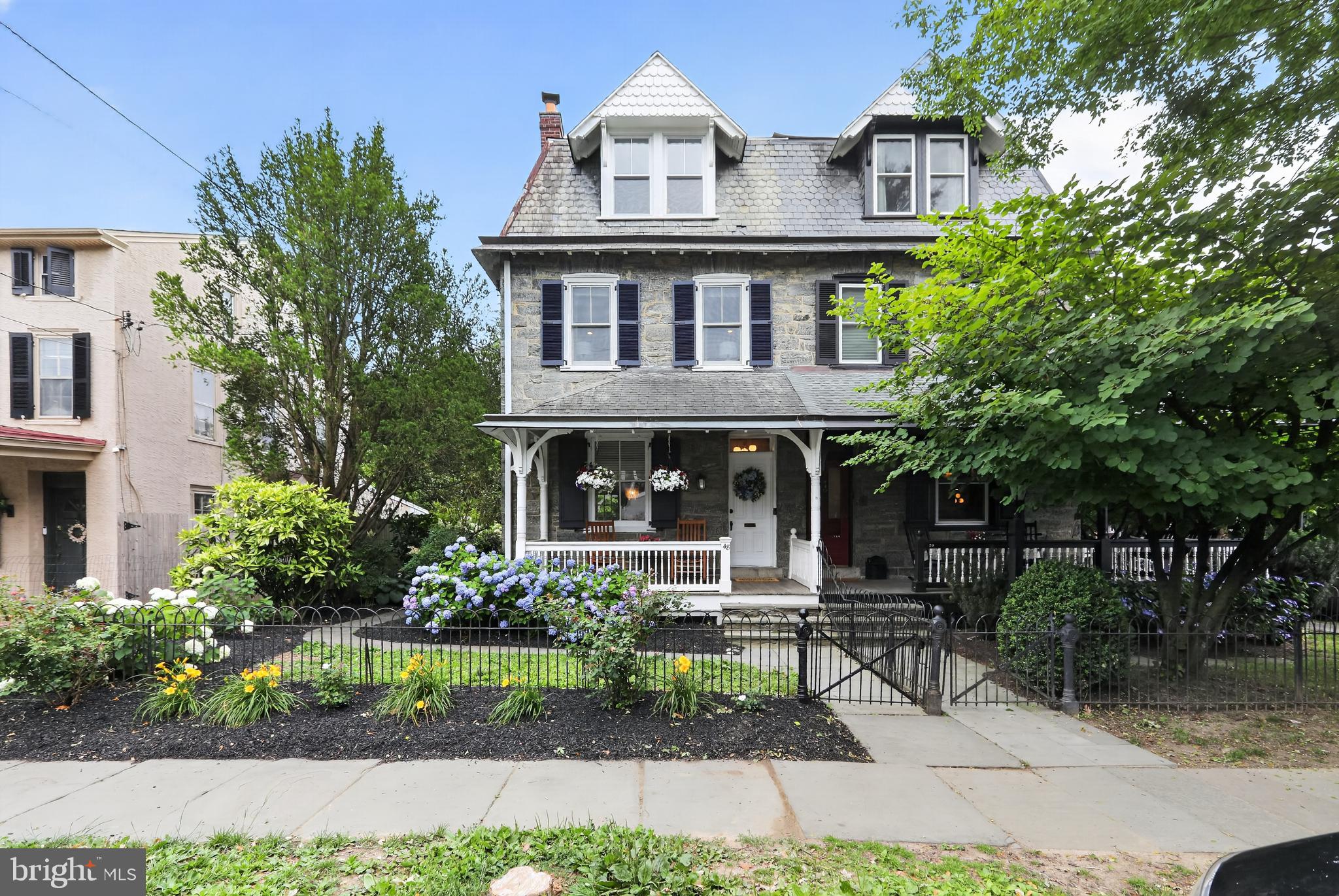 Welcome to 48 W. Highland Ave, a beautifully preserved 4-bedroom, 2.5-bath stone Victorian twin in the heart of Chestnut Hill. Developed by Henry Houston and designed by the Hewitt Brothers, this home blends historic charm with thoughtful modern updates. Just moments from Chestnut Hill's shops, restaurants, cafes, and the CH West train station, it offers exceptional walkability and convenience. Inside, you'll find a welcoming living room with custom built-ins and a fireplace, a formal dining room with updated wainscoting, and a renovated kitchen featuring quartz countertops, stainless steel appliances, a large island, and coffee bar. A bright sunroom overlooks the beautifully landscaped backyard with a patio, porch, and lush green space. Upstairs, the primary suite includes an en-suite bath and attached expansive closet that can easily be converted into an additional bedroom, office, or flex space. Hardwood floors, central air, and second-floor laundry complete this exceptional home.