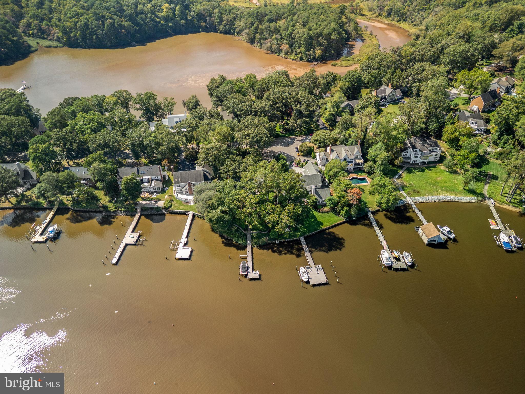 Stunning Severn River waterfront home showcasing panoramic water views and unforgettable sunrises from nearly every rear-facing room! The gourmet kitchen features Wolf and KitchenAid appliances, Brazilian quartzite countertops, custom Brookhaven cabinetry, and a large center island, complemented by a built-in bar with wine cooler—ideal for entertaining. A sun-filled four-season sunroom with stone fireplace offers year-round enjoyment overlooking the river.

The primary suite is a private retreat with a spa-inspired bath, custom dressing area, walk-in closet, and adjacent exercise room. Custom white ash built-ins enhance the family room and office with exceptional craftsmanship throughout.

Outdoor living shines with a bluestone patio, lush professional landscaping, landscape lighting, irrigation, and a private pier with Trex decking, boat lift, and access to the main boating channel. Recent improvements include a new roof and skylights (2023), extensive drainage, shoreline protection, full-height basement, and oversized garage with storage. Don't miss this rare opportunity of waterfront living, schedule your private tour today!