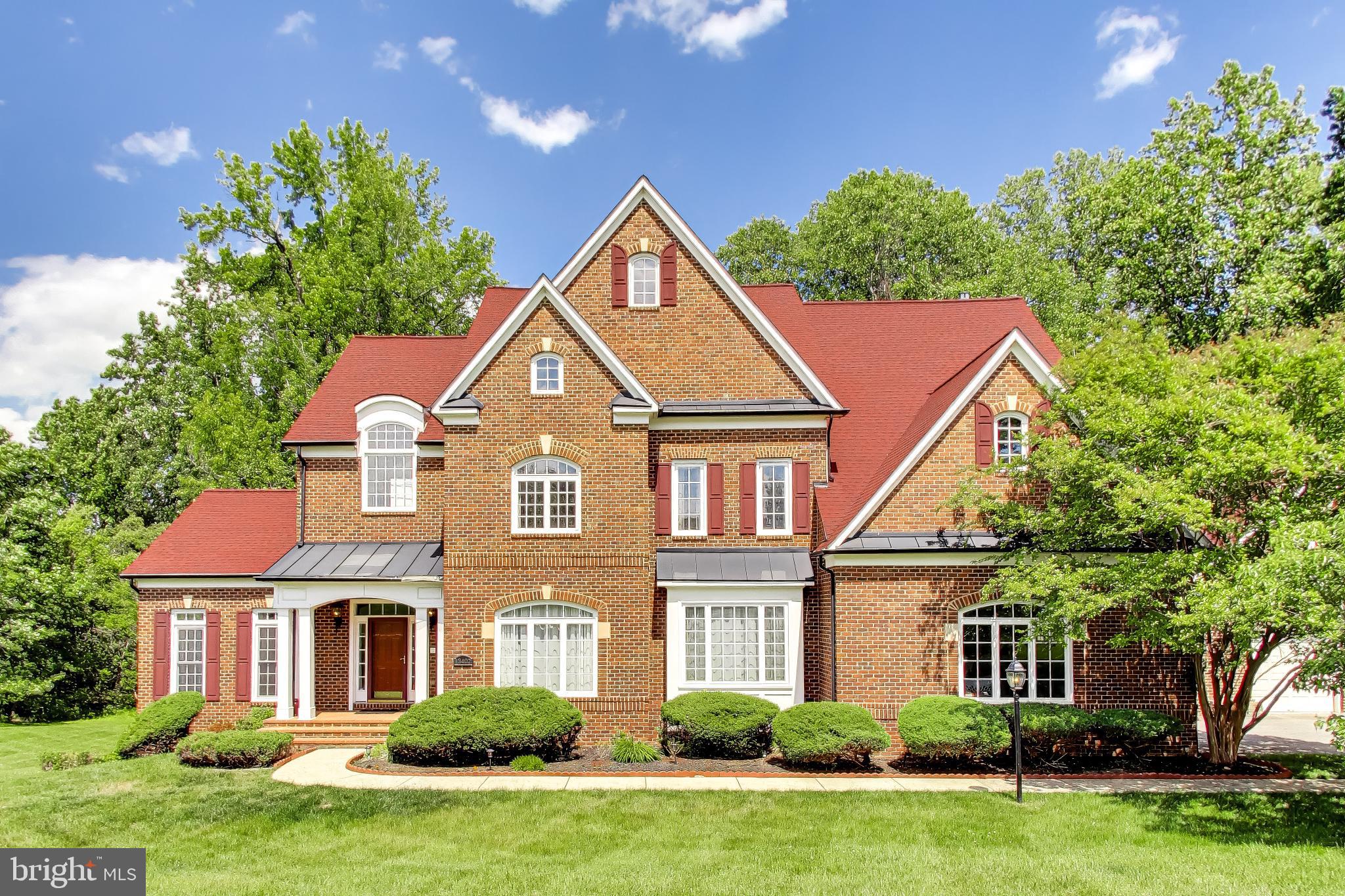 Exquisite Colonial with contemporary flair offering over 9,200 finished square feet on a private 2-acre homesite backing to trees. Designed with exceptional architectural detail and abundant natural light, this impressive estate features 5 bedrooms, 6.5 bathrooms, and additional unfinished areas offering endless possibilities for expanded living space.  A dramatic circular foyer with tray ceiling welcomes you into the home and leads to a sweeping curved staircase and stunning two-story family room featuring a floor-to-ceiling stone gas fireplace, custom built-ins, and expansive windows overlooking the private rear grounds. The elegant formal dining room is appointed with a tray ceiling, crown molding, chair railing, and butler’s pantry. The gourmet kitchen offers a large center island with breakfast bar, granite countertops, gas cooktop, double wall ovens, built-in desk area, recessed lighting, oversized pantry, and a sun-filled breakfast area highlighted by a curved wall of windows.  Additional main-level spaces include a formal living room with crown molding and transom windows, private office/study, and an impressive sunroom with Palladian windows.  The upper level features generously sized bedrooms, all with ensuite full bathrooms and walk-in closets, along with a spacious laundry room complete with utility sink and built-in cabinetry. The luxurious primary suite is a true retreat showcasing tray ceilings, custom built-ins, gas fireplace, dual oversized walk-in closets, and a spa-inspired bath with ceramic tile flooring, glass block walk-in shower with dual shower heads and bench seating, jetted soaking tub, dual vanities, and private water closet.  The walkout lower level is designed for entertaining and relaxation with a large recreation room featuring a gas fireplace, custom wet bar, media/theater room with surround sound system, additional office/study, full bathroom, and two expansive storage areas ready to be finished into additional bedrooms or living space.  Car enthusiasts and guests alike will appreciate the attached side-load 2-car garage plus a detached 2-car garage featuring a loft/nanny suite complete with bedroom/living area, full bathroom, and walk-in closet.  Additional highlights include four-zoned HVAC heat pump systems with natural gas backup, newer roof, gutters and gutter guards, and a new water filtration system. The exterior offers endless possibilities for outdoor living, entertaining, and recreation in a serene private setting.