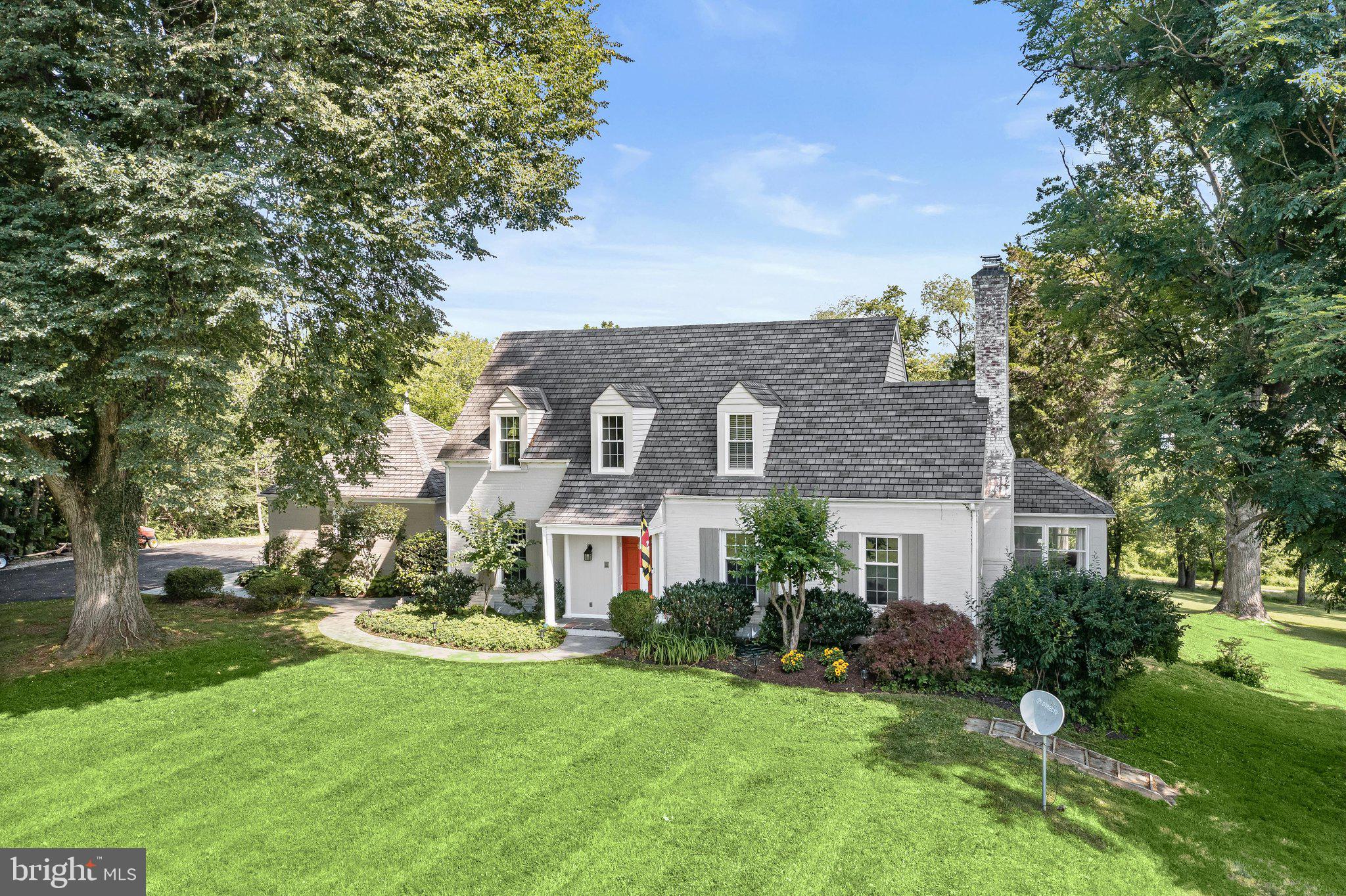 Nestled on more than 6.5 picturesque acres, this exceptional equestrian estate seamlessly blends timeless Cape Cod architecture with the tranquility of country living. Surrounded by beautifully landscaped grounds and scenic walking paths, the property is thoughtfully designed for both horse enthusiasts and those seeking a private retreat. Outdoor amenities include a detached two-car garage, hot tub, patio, storage shed, outdoor riding arena with sand footing, fenced pasture with paddock, and three stall shed row barn with tack room.  A classic brick exterior welcomes you into an elegant interior where stunning hardwood floors and refined architectural details create an atmosphere of warmth and sophistication. The formal living room showcases soaring ceilings, crown molding, graceful arched doorways, custom built-in bookcases, and a wood-burning fireplace framed by a traditional mantel and decorative accents. Adjacent to the living room, the formal dining room is perfectly suited for both intimate gatherings and grand entertaining, featuring crown molding, chair railing, and charming built-in corner bookcases.  The sunroom offers a versatile space filled with natural light, highlighted by slate flooring, exposed brick accents, and captivating views of the surrounding grounds. Designed with both beauty and function in mind, the gourmet kitchen features 42-inch cabinetry with pull-out drawers, granite countertops, stainless steel appliances, and convenient access to the mudroom with ceramic tile flooring.  The main level features a spacious primary suite or guest retreat, complete with a serene neutral palette and a beautifully appointed en-suite bath adorned with timeless tile. Upstairs, a second primary suite option awaits, featuring two walk-in closets, large sun-filled windows, central vacuum, and elegant arched doorways. A generously sized secondary bedroom with a walk-in closet, hall linen closet, and full bath with ceramic tile and a tub-shower combination completes the upper level.  The fully finished lower level offers exceptional flexibility for today’s lifestyle needs. A spacious recreation room, an additional bedroom with a potential walk-in closet, an office or optional fourth bedroom, a full bath, and an expansive utility and laundry room provide abundant living space. A second full kitchen further enhances the lower level, creating an ideal setup for extended guest accommodations, an au pair suite, or multigenerational living.  Offering the perfect balance of luxury, privacy, and equestrian functionality, this remarkable estate enjoys convenient access to I-70, US-29, and MD-200, providing easy travel to downtown Baltimore, Washington, D.C., and destinations beyond.