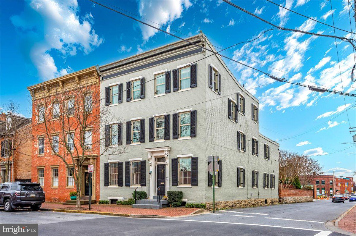 This beautiful 1880 home is perfectly situated on the corner of Church and North Carroll Streets in the heart of historic downtown Frederick. Overflowing with timeless charm, the property captures the essence of historic architecture while offering modern comforts, making it a rare find in one of the most sought-after locations in Frederick. Inside, you’ll find six spacious bedrooms and three full bathrooms, each brimming with character. The home’s historic hardwood flooring adds a touch of warmth and authenticity, complementing the property’s classic details. The recently renovated kitchen is a standout feature, boasting top-of-the-line appliances, custom cabinetry, and elegant countertops, providing both functionality and style. The private rear courtyard is a serene escape, perfect for outdoor dining, gardening, or unwinding in a peaceful setting. The property’s corner lot location enhances both its curb appeal and convenience, offering easy access to Frederick’s vibrant downtown filled with shops, restaurants, and cultural landmarks. This home offers the unique opportunity to own a piece of Frederick’s history in one of the city’s most picturesque settings, blending historic charm with everyday practicality. Whether entertaining or simply enjoying the downtown lifestyle, this property is truly one of a kind.