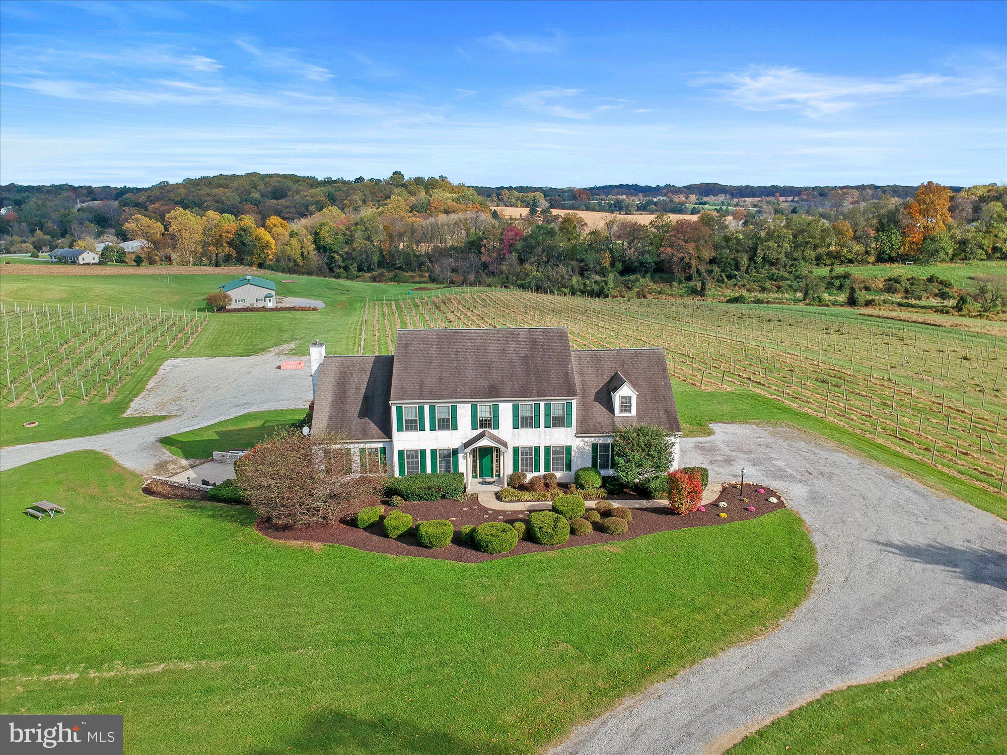 Opportunity of a lifestyle is calling! You just need to decide what your lifestyle and calling is. For the current owners, it was Kreutz Creek Vineyard and Event Venue, a hobby they started, in 1989, and grew into a 20 acre estate featuring 8 acres of grapevines used to produce award winning wines. Production included growing, bottling, labeling, corking, and capping by hand. Memories were made with weddings and concerts in the vineyard. The property is zoned for a Bed and Breakfast, and events up to 125 guests, three times a week. The owners are now ready to retire, but that doesn’t mean you can’t have a dream. This might just be the perfect time, to explore the possibilities presented with this estate. Maybe you also love wine and dream of growing your own grapes; maybe you love horses. There is a pretty sweet detached barn, with electric, water and three 10x10 overhead garage doors. Maybe you have hobbies with lots of toys; or maybe you just want to get away from it all.  No matter your dreams, they can be answered when you become the new owner of this 3600+ square foot residence, set on 20 of the most beautiful acres this side of heaven. The home features spacious rooms, cathedral ceiling family room, huge eat-in kitchen, 1st floor laundry room, primary suite with a 10x13 primary bath, and so much more. There is also an attached 3-car, end-load garage.  The lower level is partially finished as it used to host wine tastings. There are several rooms and lots of possibilities. A side entry door leads to a patio area overlooking the grounds. If you are nervous you might miss city life, great news, you are a short commute to Kennett Square, Chadds Ford, Longwood Gardens, and Philadelphia.  What are you waiting for!?! If you are one of the few who can afford it, you owe it to yourself to schedule a showing, of this once-in-a-lifetime opportunity.  AGENTS – Please read Agent Remarks!