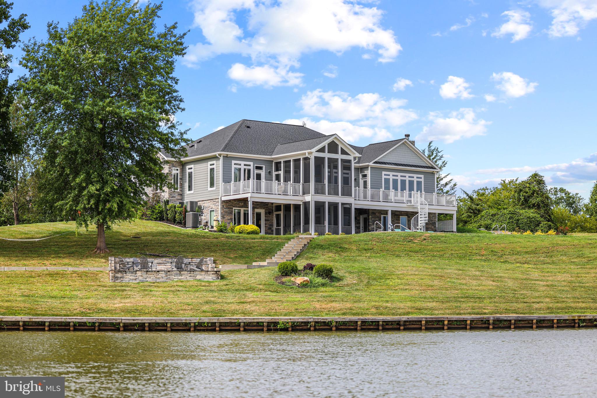 Waterfront Lake Living at it's Finest!!! Approximately 500' of Shoreline!  This Prestigious Home is Custom Built with  Hardie Plank Siding & Stone Showcases Tons of Upgrades, Luxury in ground pool and Features almost 5,000 Finished Sq. Ft Nestled on 5.5 Acres! 5 Bed/4 Full Bath, Hardwoods, Laundry Room on Both Levels, Attached 2 Car Garage w/Separate Golf Cart Entry, Gourmet Kitchen and Open Floor Plan. Main Level Living w/10' Ceilings! Kitchen is a Cooks Dream w/ all Stainless Steel Appliances, Gas Cooking, Double Oven, Quartz Countertops, 8' Cabinets, Prep Sink and Island. Primary Bath w/ Trey Ceilings and Gorgeous Ensuite. Soak Tub, Shower Stall, Double Sink, Granite Countertops and Custom Tile Work. Screened in Porch off Kitchen for Additional Dining and Breathtaking Views. Additional Bedroom and another Full Bath on Main. Lower Level Features 9' Ceilings, Bonus Room/Family Room, Pool Table, Ping Pong Table, 1200 Bottle Wine Cellar, 3 Full Bedrooms/2 Full Bathrooms, Walk Out to Volleyball, Basketball, Hot Tub, Extensive Hardscaping to Fire Pit and Amazing Dock!! 13 Zone, 2 Acre Underground Irrigation System w/Remote Access. 1500 Gallon Underground Propane. Flagstone Walkway, Brushed Concrete LED Lit Steps to Boathouse with Hardie Plank and Composite Flooring! Electric Lift for Boat and Jet Ski 's. All Interior and Exterior Furniture Conveys. This Luxury Lake Anna Home is the Perfect Investment Property for Vacation Rentals, Full Time Family Home or Weekend Getaways! Just Minutes to Restaurants like Tim's and The Cove! Not to mention this property comes fully furnished!!! What you see in those extravagant photos is what will come with the home!! Don't miss out on this killer opportunity!