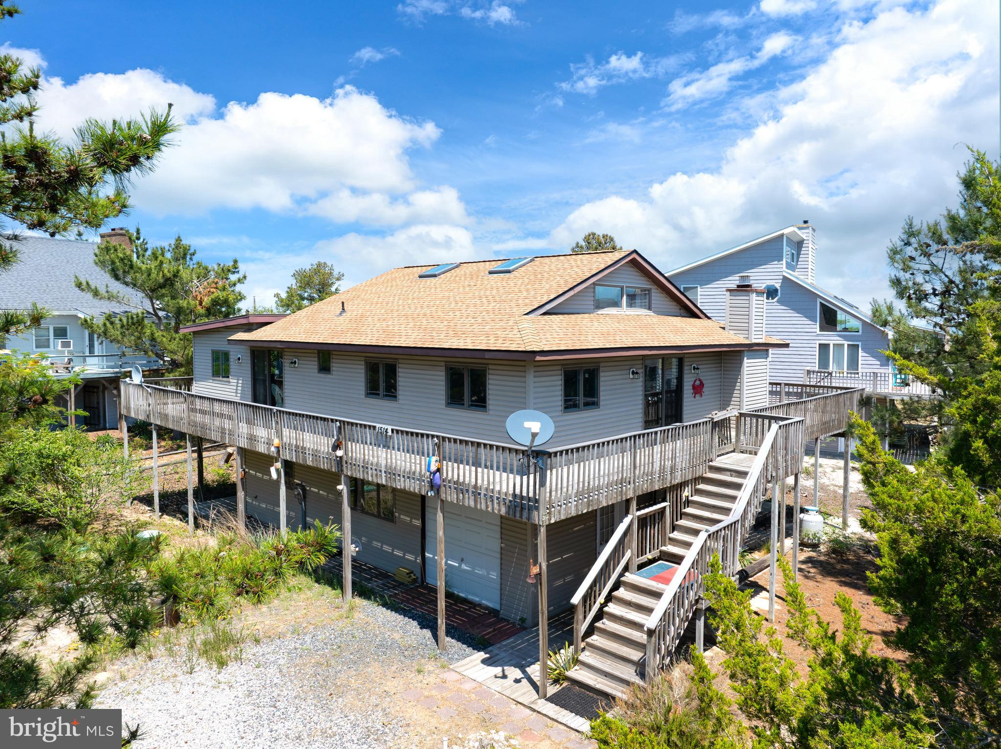 Experience the charm of Broadkill Beach in this spacious coastal retreat located just a short walk from the shoreline. Offering 2200+ square feet of living space, this inviting home blends classic beach-house character with comfortable indoor and outdoor living designed for relaxing, entertaining, and enjoying life by the water.

Inside, the bright and airy kitchen features a center island, skylights, and abundant natural light, creating a welcoming space for gathering with family and friends after a day at the beach. The open living area offers a warm and comfortable atmosphere complete with a cozy fireplace for cooler coastal evenings.

One of the standout features of the property is the expansive wraparound deck, providing multiple outdoor spaces to dine, unwind, entertain guests, or simply enjoy the coastal breeze. Additional deck and patio areas create seamless indoor-outdoor living throughout the property.

Situated on an oversized 0.22-acre lot with parking for multiple vehicles and a round driveway, this home offers the perfect opportunity for a full-time residence, vacation getaway, or investment property near the Delaware coast. Enjoy the peaceful atmosphere of Broadkill Beach while remaining just a short drive to Lewes, shopping, dining, and local attractions.

Whether you are spending summer days on the beach, hosting weekend gatherings, or enjoying quiet mornings outdoors, this coastal home offers the laid-back lifestyle that makes Broadkill Beach so special.