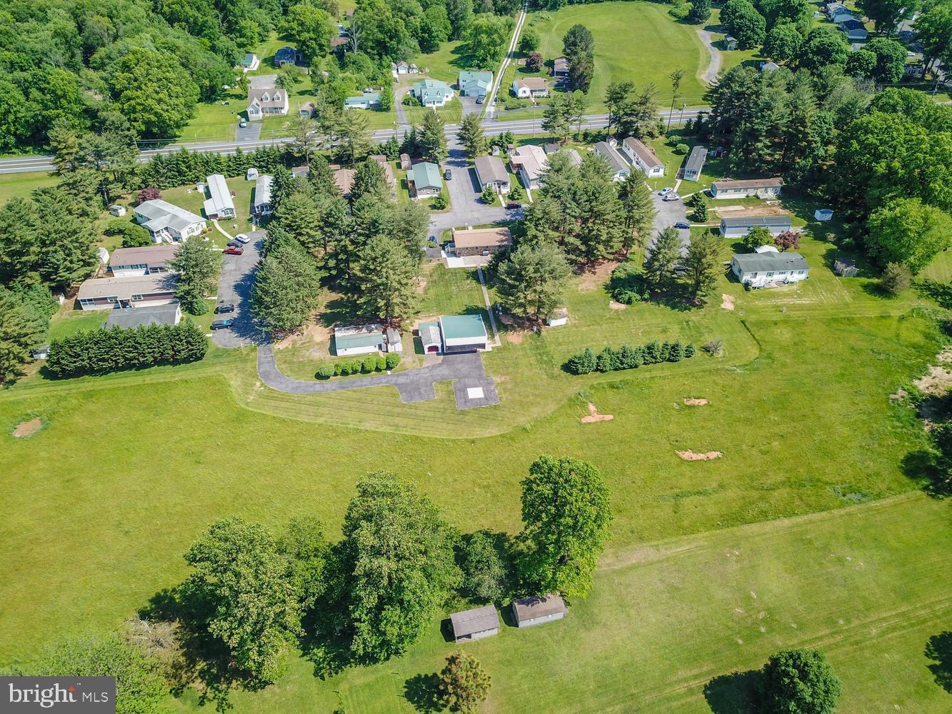 Rare investment opportunity ​to own a well-maintained 55+ mobile home community situated on 10 acres with 20 mobile home lots plus an ​updated Ranch​er with an In-Law Suite. This unique property offers multiple income streams with established lot rentals while also providing the option for owner occupancy or additional rental income from the rancher and outbuildings. Peaceful setting with ample open space, mature trees, and ​situated next to a park. The ranch home offers comfortable single-level living and is ideal for an onsite owner/operator, property manager, or supplemental income opportunity. The Rancher also features an In-Law Suite with a bedroom, full kitchen, living room, and it's own entrance. Conveniently located on Route 1 yet still peaceful/quiet and bordered by trees. Excellent opportunity for investors seeking stable cash flow, long-term growth potential, and a versatile income-producing property. Owner Financing Considered. Current Lot Rents $522.50/month. Property also includes multiple sheds/garages and a helicopter hangar.
