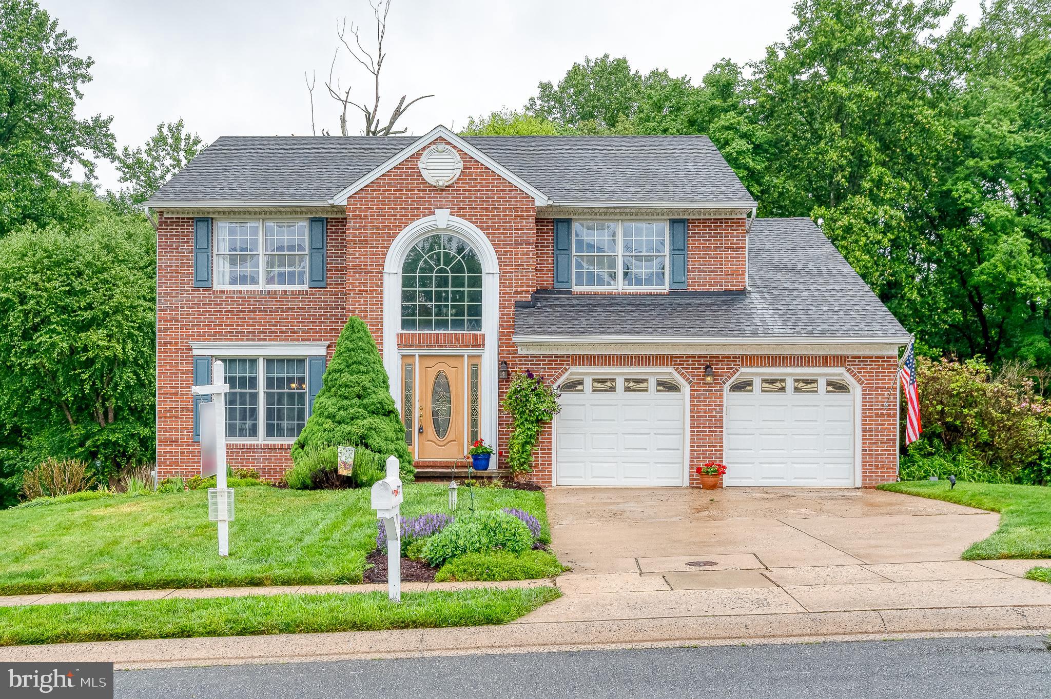 Welcome home to this beautifully maintained colonial featuring a dramatic two-story foyer with ceramic tile flooring and a palladian window that fills the space with natural light. You'll find formal living and dining rooms, with the dining room having previously been converted to a main-level bedroom and easily capable of serving that purpose again for buyers seeking first-floor living flexibility (full bath is already there). The updated kitchen features white cabinetry, granite countertops, stainless steel appliances, and a slider leading to the maintenance-free deck overlooking the backyard. Crown molding and chair rail accents add character. The sunken family room has a fireplace as its focal point. Upstairs, the spacious primary suite offers two closets and a renovated primary bath with a double-sink vanity. Three additional bedrooms and a hall bath complete the upper level. The walkout lower level awaits your finishing touches and opens to a second maintenance-free deck and fenced rear yard backing to mature trees, providing privacy and a peaceful setting.