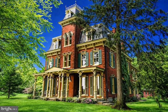 Historical mansion for sale in Eastern Lebanon County. ✅ 10 bedrooms, 9 fireplaces, 11' ceilings, 7395 SF, Approx 2 acres. The Mansion in The Pines - ✅ 1860 Victorian: Second Empire. Central PA- Less than one hour to Philadelphia!  ✅ Welcome to The Mansion in The Pines, a hidden gem brimming with history and luxury in Central Pa.  Nestled on 2.4 private acres, this private home offers an unparalleled experience, combining historical intrigue with modern comforts. Built in 1860 as a summer retreat for Isaac Long, this three-story mansion is rumored to have played a role in the Underground Railroad, adding a layer of mystery to its storied past. Today, the mansion stands as a testament to timeless elegance, lovingly restored to its former glory while accommodating contemporary needs. Step inside and be captivated by 21 meticulously crafted rooms spread across 7,395 square feet. The mansion features 10 bedrooms, 2.5 bathrooms, and 21 beds, ensuring ample space for guests. The grandeur of 11-foot ceilings (on all three levels) and the elegance of dual staircases—one for the main quarters and one built for the servants—set the stage for an unforgettable stay. The Mansion in The Pines is replete with unique and charming features. A lookout tower offers breathtaking panoramic views of the surrounding countryside, inviting guests to unwind and take in the beauty. The chef's kitchen is designed for culinary enthusiasts, while the grand living room is perfect for hosting memorable gatherings. Throughout the mansion, marvel at the architectural details: triple-brick thick interior & exterior walls, 13 copper dormers, 6 chimneys, 9 gas fireplaces plus a glass front wood stove in the old kitchen walk in fireplace — all showcasing its historical craftsmanship. Outdoor spaces include four porches including a balcony, each providing a tranquil spot to relax and enjoy the serene surroundings. The estate also boasts two laundry areas—one in the summer kitchen (former butlers kitchen) and another in the basement.  The 24x26 2 car detached garage offers additional convenience. The Mansion in The Pines is ideally situated for exploring the best of Central Pennsylvania. Its authentic character and refined elegance make it a standout destination, far from ordinary and truly one of a kind. Prepare to be captivated by the magnificent details and timeless beauty of The Mansion in The Pines. The architecture is second empire.  Staged photos. Professional photos in July! Please keep off property except by confirmed scheduled appointment.  Shown by appointment only, with possession available during Summer of 2026.  Curious to uncover more? Schedule your private tour and discover the secrets waiting within this extraordinary estate.  It’s really not too good to be true.