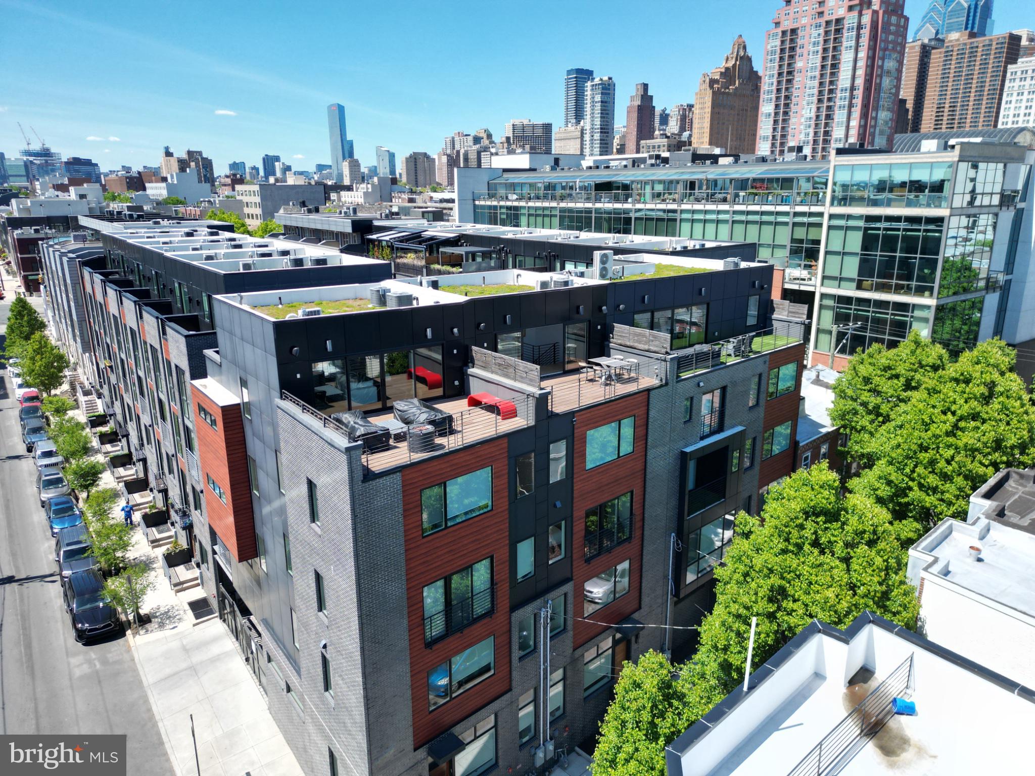 This exceptional 22-foot-wide luxury townhome at Kater Court offers 2-car garage parking, a 5-stop elevator, four outdoor spaces, and a tax abatement through 2032, with 2026 real estate taxes of just $4,123.53. Nestled within a quiet gated community, the home provides a rare combination of privacy, scale, and convenience in the heart of Center City.

Designed for both everyday comfort and sophisticated city living, the home showcases an extraordinary level of craftsmanship and attention to detail. Herringbone flooring, wide-plank hardwoods, custom millwork, Porcelanosa tile, Waterworks fixtures, elegant stone surfaces, and handcrafted cabinetry create a refined yet welcoming atmosphere throughout.

The main living level is both impressive and highly functional, anchored by a striking fireplace and a chef’s kitchen designed to be the centerpiece of the home. High-end appliances, custom cabinetry, a large waterfall-edge island, generous prep space, designer lighting, and oversized windows create an ideal setting for both entertaining and daily life. The home’s rare 22-foot width provides an exceptional sense of openness that is difficult to find in a Philadelphia townhome.

The owner’s suite serves as a true retreat, featuring oversized windows, a spacious sitting area, expansive walk-in closets, and a spa-inspired bathroom complete with a freestanding soaking tub and glass-enclosed shower.

One of the home’s most distinctive features is the enclosed rooftop lounge with its own full bathroom, creating a true all-season living space rarely found in the city. Whether used for entertaining, working from home, hosting guests, exercising, or simply relaxing above the skyline, this versatile space offers exceptional flexibility. The adjoining rooftop terrace also benefits from added privacy compared to many neighboring properties, creating a comfortable setting for outdoor dining, lounging, and entertaining.

The lower level adds valuable functionality with radiant heated floors and a large dedicated storage room, a rare and highly practical feature in Center City living.