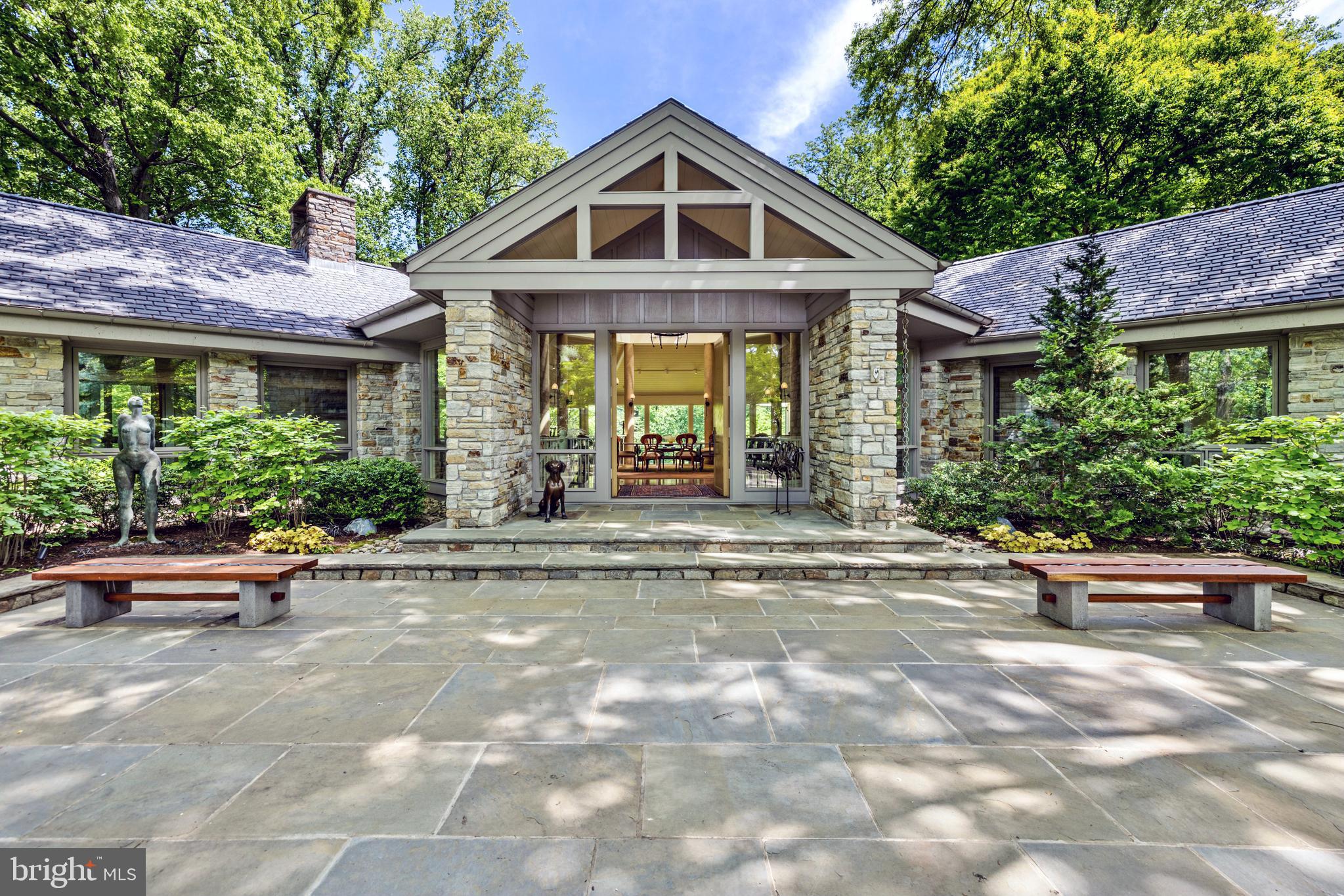Style meets elegance in this stunning 4-bedroom contemporary stone and cedar home, nestled on 4+ private, wooded acres in the Ruxton area. Featuring an impressive 28' glass domed ceiling at its center, this light filled retreat creates a seamless blend of indoor and outdoor living that is as remarkable as it is breathtaking. The open-concept layout and soaring ceilings combine with the abundance of light to create a bright and airy atmosphere throughout. The gourmet kitchen features top-of-the-line appliances, sleek cabinetry, and ample counter space for all your culinary creations. Main level living offers spacious bedrooms with plenty of closet space and natural light which pours in through large windows. The master suite is a true sanctuary, complete with a spa-like ensuite bath with heated floors. 
Step outside onto the beautiful terrace and enjoy the tranquil setting, surrounded by mature trees and lush greenery. 
The three-car garage is complete with a charging station for electric cars, and an elevator offers convenient access to all levels of the home.  No need to worry about storms, the home comes with a generator. 
This home is a rare gem, offering the perfect blend of modern design and natural beauty. Don't miss out on the opportunity to make this extraordinary property your own.