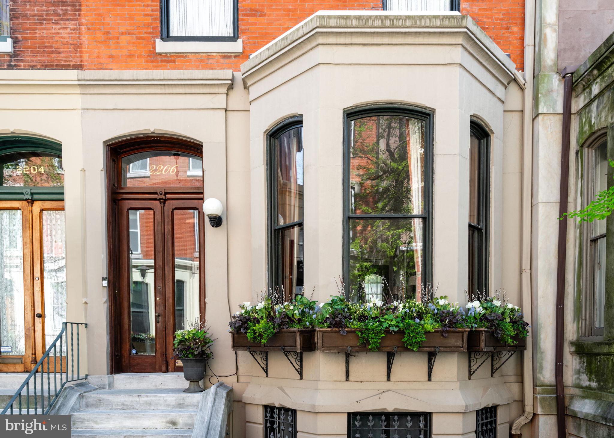 Welcome to 2206 Delancey Place - An exquisite 20 ft wide townhouse nestled on a quiet tree-lined street, steps from Fitler Square park. This meticulously crafted residence with 2 private outdoor spaces spans over 3500 SF across 4 levels allowing for spacious rooms and an ideal floor plan with 4 bedrooms + office/den, 4 full bathrooms and a powder room. 

Enter through the vestibule into the open living room with high ceilings, large windows and natural light that floods the interior, creating an inviting ambiance throughout, only enhanced by a stunning gas fireplace. The south-facing eat-in kitchen with custom cabinetry and stone counters, walks out to a lovely deck overlooking the private garden. Also on this level is a walk-in pantry and conveniently located powder room. 

The second level features an elegant primary suite, adorned with built-in wardrobes and a luxurious bathroom complete with a soaking tub, oversized shower, and double sink vanity. Adjacent to the primary suite is a handsome den, currently used as an office, graced with a stately fireplace and custom millwork, perfect for moments of relaxation or productivity. Additionally on this level is a conveniently located laundry room.

The third level offers three bedrooms and two full bathrooms, providing ample space and privacy for family and guests. A finished lower level offers endless possibilities for use as a private guest suite, home gym, playroom, media room, or studio. A full bathroom, cabinetry, and a walk-out entrance to the garden further enhance its versatility.

This prime location immerses you in the heart of the Fitler Square neighborhood, surrounded by local restaurants and shops such as Sally, Bacchus, Trattoria Carina, Good Karma, and more. Located in the Greenfield School catchment, and a short walk or bike commute to Penn, HUP, CHOP, Drexel & 30th Street Station.

Seller is offering one year prepaid parking at a neighborhood lot.