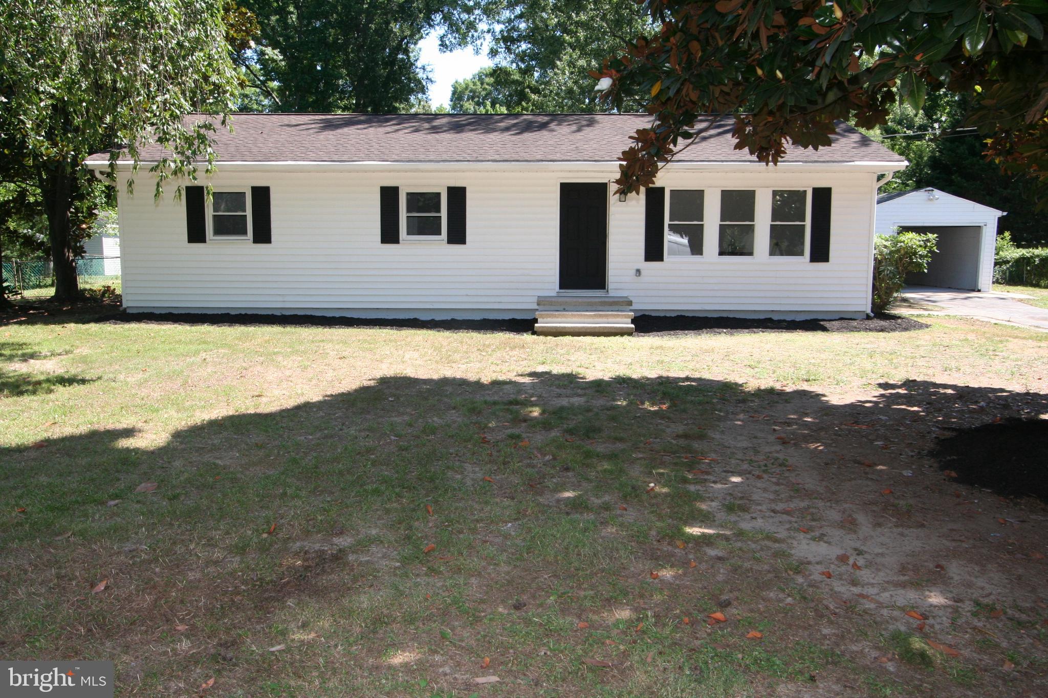 Welcome to your dream coastal retreat on Kent Island! This completely updated 4-bedroom, 2-full-bath rambler sits on a sprawling, tree-lined half-acre lot, offering the perfect blend of modern luxury and active outdoor living. A large, detached garage adds exceptional storage space for your vehicles, golf cart, and coastal gear. Step inside to find a light-filled layout highlighted by a spectacular gourmet chef’s kitchen. Outfitted with stainless steel appliances, a deep stainless sink with a high-arc faucet, and a sleek 4-burner gas stove with a center griddle, this kitchen is a home chef's paradise.The single-story floor plan features four generous bedrooms and two beautifully updated full baths, maximizing comfort and convenience. The primary bedroom has been expanded and the gorgeous primary bath has a high quality, walk-in shower and distinctive, touch of class vanity.  Outside, your private half-acre oasis connects seamlessly to the local lifestyle. Enjoy immediate access to the tree-lined walking, biking, and golf cart paths leading directly to the neighboring Blue Heron golf course and driving range. Best of all, you are just 5 miles away from sandy days at Matapeake Beach and sunset fishing at the pier. Don't miss this rare Kent Island gem!