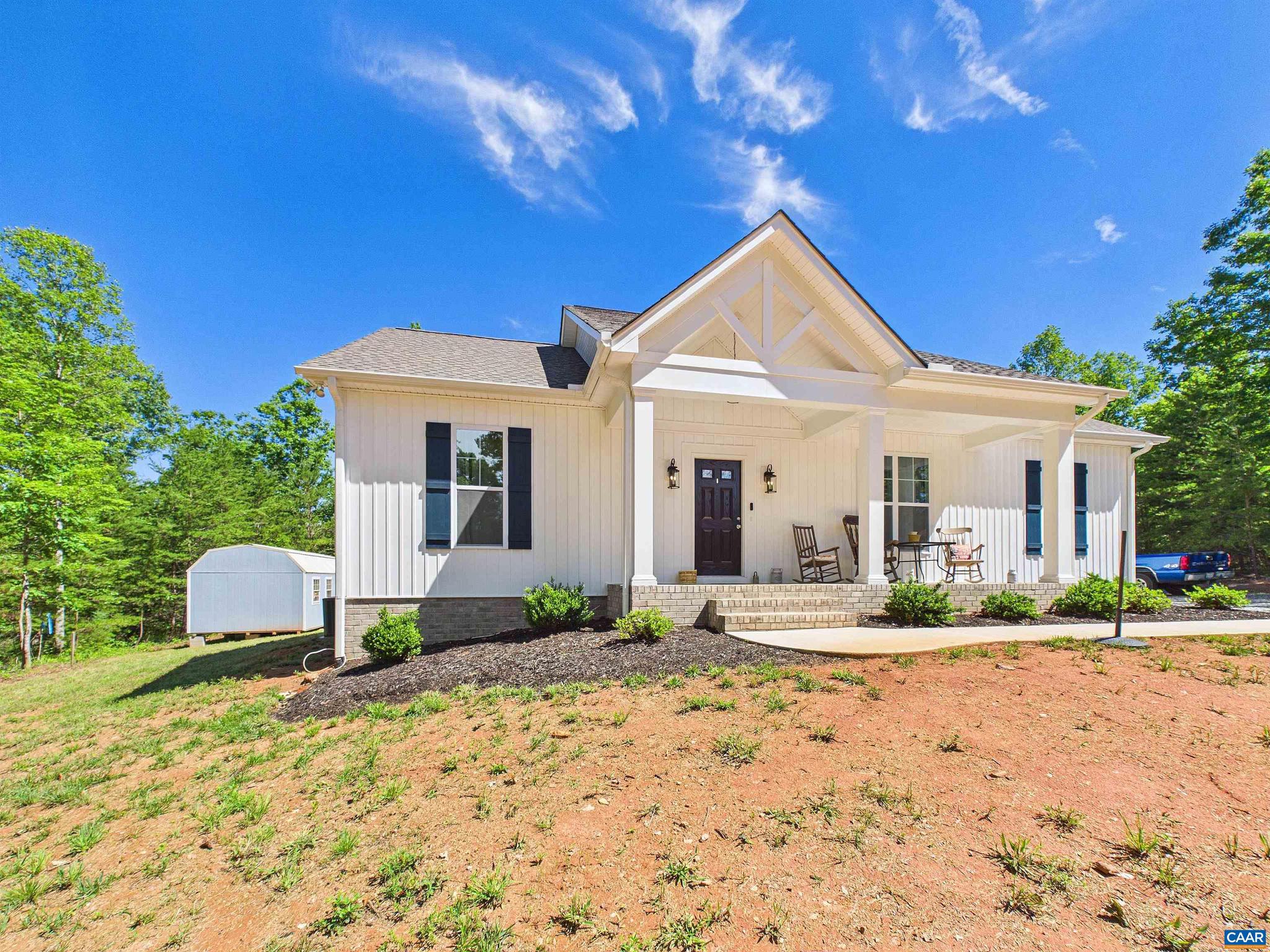 Welcome to this stunning 3 bedroom, 2 bathroom retreat offering the perfect blend of modern comfort and peaceful living. Step inside to an airy, light filled open concept floor plan crowned by magnificent cathedral ceilings. The grand main living area flows seamlessly into the dining space and a gourmet kitchen, making it an entertainer's dream. The chef-inspired kitchen stands as the heart of the home, boasting premium Merillat cabinets, sleek granite countertops, and a massive center island perfect for meal prep. Gorgeous, durable luxury vinyl plank (LVP) flooring flows throughout the main living spaces, combining everyday functionality with elevated style. Outside, the spacious property features a highly desirable bonus: a detached storage shed fully equipped with electrical power ideal for a workshop, hobby space, or extra storage. This move-in-ready gem offers unmatched tranquility without sacrificing contemporary luxury.