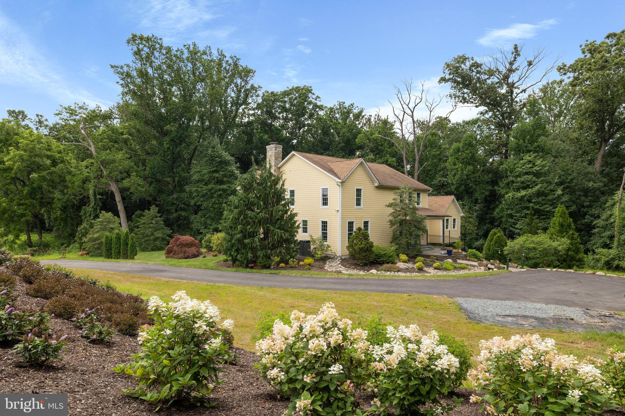 Custom Hardiplank farmhouse in exquisite setting in Monkton. Enjoy the tranquil sounds of the two water features while relaxing on your bluestone patio. First floor Primary Suite with deck overlooking the woods. Primary Bath has an air bubble tub and glass enclosed shower with river rock floor. Gourmet kitchen with two story ceilings, marble counters, gas cooktop and lots of cabinet space. Upstairs has a potential second Primary Suite with ensuite bath and two additional bedrooms and a full bath. Lower Level has a rough in for a bath, high ceilings, a walk out and can be easily finished. Garage permit has been secured, foundation floor complete. Just need to add doors, walls and roof to finish. If you enjoy the peaceful sounds of the outdoors, then this is your dream home! Minutes from NCR and Gunpowder for Tubing.