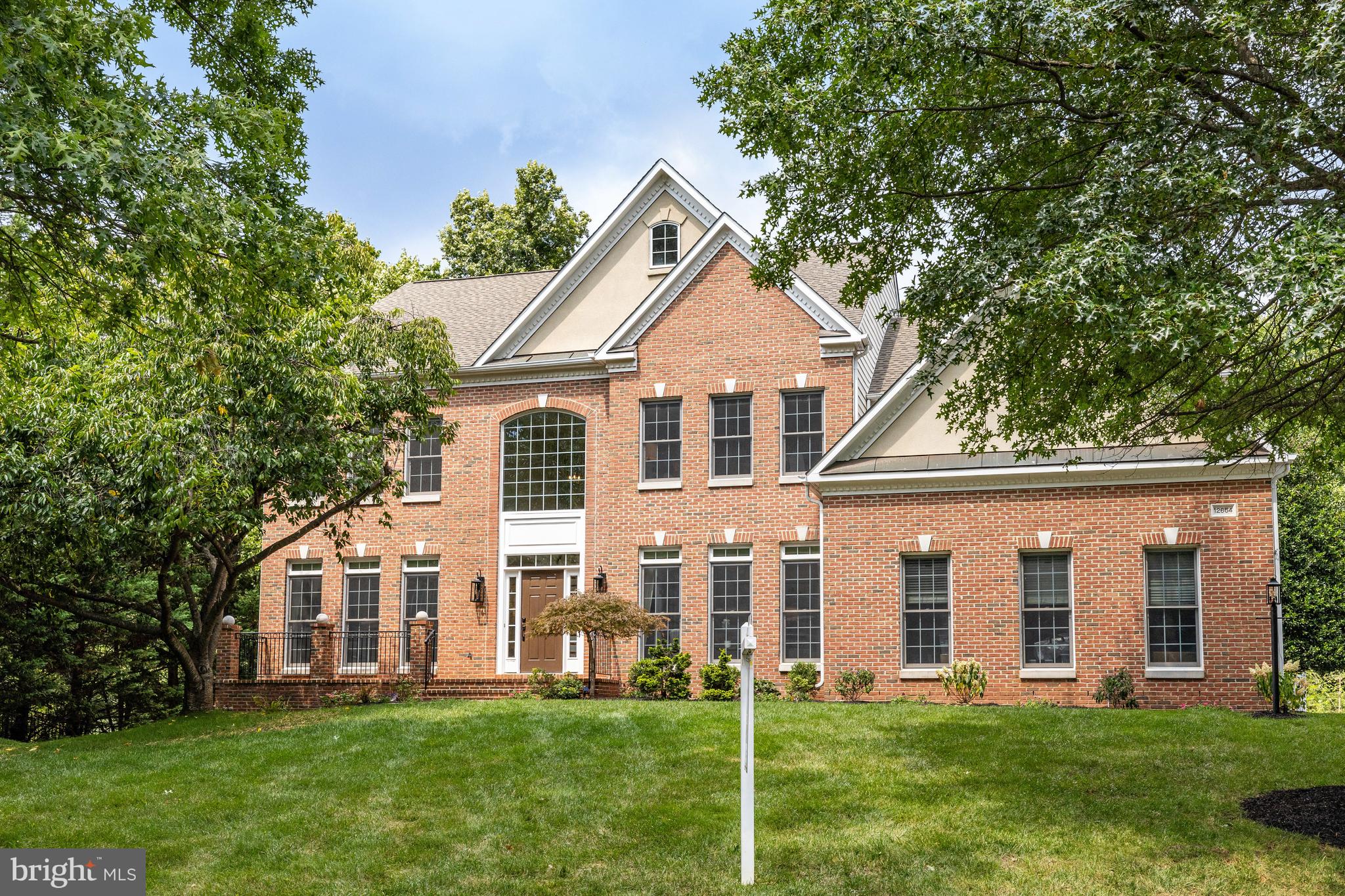 Set in the highly desirable Oak Hill Estates neighborhood, this one-of-a-kind home is beautifully situated on a premium 1.24-acre cul-de-sac lot backing to trees. Zoned to top rated Oakton High School Pyramid. At over 6,000 square feet, this home exudes a sense of grandeur and warmth, offering abundant space and flexible living opportunity. The two-story foyer welcomes you to a bright, open and light interior which seamlessly flows into the living room and formal dining room. As you step into the impressive entry, you'll be greeted by a stunning grand curved staircase, high ceilings and hardwood flooring from the grand entry hall into the expansive kitchen and breakfast nook. The recently updated large gourmet kitchen is a chef's haven equipped with premium stainless-steel appliances, a walk-in pantry and stunning new quartz countertops. A central feature is the large island with a multi-burner gas cooktop allowing the cook to interact with family or guests. Ample room for large gatherings and entertaining. The kitchen flows to an expanded two-story family room with a gorgeous stone surround gas fireplace and a wall of windows overlooking the deck and yard.  French doors open to the large deck, pergola and backyard. Adjacent to the kitchen is a spacious light-filled breakfast room which opens to a beautiful screened porch, perfect for al fresco dining, relaxing, and stylish entertaining. The deck and screened porch are made of luxurious Ipe (Brazilian Walnut Hardwood). In addition, the main level features an office with French doors, laundry room and a three-car side-load garage with loads of storage space! Upstairs, you will find an expansive primary suite with tray ceiling, sitting area, and a newly renovated ensuite spa bathroom featuring double sinks with quartz counters, a stand-alone deep soaking tub, and expanded shower. TWO HUGE walk-in closets add to the luxury. The upper level has a second staircase which leads to the kitchen, all new neutral carpet and hosts three additional spacious bedrooms - one with an ensuite bathroom and the other two bedrooms sharing an updated Jack & Jill bathroom with a double vanity with new quartz countertop. The fully finished walk-out lower level adds an additional dimension to this already impressive home. Ideal for movie nights, game days, or simply lounging, this versatile space offers endless possibilities. The lower level offers two additional bedrooms and a full bathroom ideal for guests or in-law suite. The lower level has all new Berber carpet, a large rec room, media room with a movie screen, a room ideal for an office or gym, a storage room with a workbench and easy access to the outdoor lower patio. Outside, the expansive backyard is a sanctuary with views of wildlife and trees. Spacious whether you're sipping your morning coffee on the expansive deck or hosting summer barbecues in the tree-lined backyard, outdoor living has never been more inviting. Driveway repaved (2024), Kitchen Update (2024), Primary Bath Renovation (2024) Bathrooms Refresh (2024) New Chandeliers, Fixtures & Recessed Lighting (2024) New carpet (2024), Entire Interior Painted (2024) Roof (2015), Upper HVAC Unit (2023), Lower HVAC Unit (2019) 74 Gallon Water Heater (2019) and so much more! Convenient to all the DC Metro Area, this home offers the perfect blend of privacy and accessibility. With easy access to shopping, dining, two international airports (Dulles and Reagan), Fair Oaks Hospital, and the nearby International Country Club. Don't miss the perfect place to call home! Open House 8/2/24 from 1-4pm & 8/324 from 1-4pm.