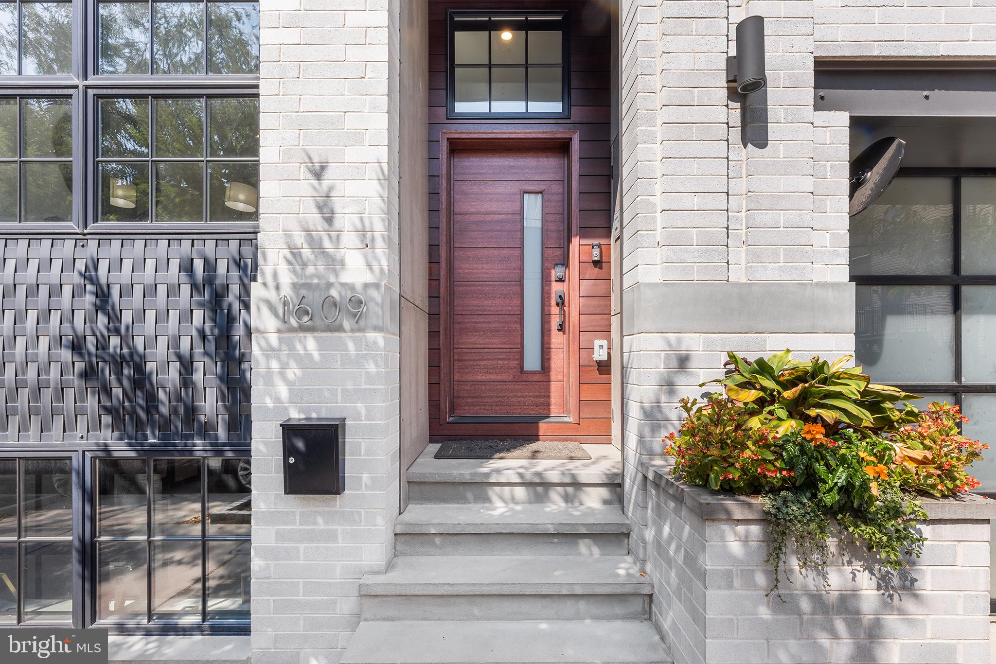 Welcome to 1609 Montrose Street, luxury at it’s finest in the heart of Graduate Hospital, with 2-car parking and roughly 7 Years left on the Tax Abatement. This 4 Bedroom, 3.5 Bathroom home consists of almost 4,000/SF of living space and it’s 24 foot wide floor plan gives off suburban living vibes in an urban setting. Oak flooring is throughout the home and laid in a herringbone pattern on the 2nd Floor where you will find a living, dining & kitchen setting like no other in the city. 12 foot ceilings and enormous windows allow the home to soak in sunlight until dusk. The kitchen, situated in the middle, is a chef’s dream, equipped with Wolf & Sub-Zero appliances, a custom white, flat panel kitchen, huge island and Dekton countertops that run up as the backsplash. Towards the front of the house you will find a powder room and the dining area, large enough to fit the table for your choice of a buffet, bar cart and any other pieces you wish. Towards the back of the home you will find a gas, vented & tiled fireplace that is the focal point of the grand living room. A 4-piece glass door patio slider leads out onto a rear deck that when left open will make for some amazing indoor/outdoor living with skyline views. Head up the custom steel stringer, solid oak tread staircase to the 3rd floor where you will find the Primary Suite where city skyline views can be seen from your window. The Primary bedroom is large enough to fit the King bed of your choice, has a luxurious en-suite, large format tiled, 4-piece bathroom with a freestanding soaking tub and a wrap around walk-in closet completely outfitted. Down the hall you will find the laundry room with cabinets and a sink and another large bedroom, complete with a modern tiled ensuite bathroom. Up the next flight of stairs you will find the expansive roof deck where the skyline view is unmatched and it is complete with trex decking, a retractible roof, an outdoor kitchen and amazing lighting that will make you want to spend as many days as possible outdoors. On the first floor you have a foyer when entering along with a secondary living space, 2 large bedrooms with great closet space and a full bathroom. Downstairs in the basement, you will find an office that can moonlight as a workout space as well, closets and your 2-car garage that also has ample space for storage. This beauty is complete with LED recessed lighting throughout, with smart switches, fully Alexa enabled, cameras, built-in speakers, multi-unit HVAC, a tankless hot water heater and more to help make the house run efficiently. Only 4 of these homes were built and this is the first one to be offered again. Don’t miss your chance to own one of the finest homes in town. With a WalkScore of 98, 1609 Montrose St is a Walker’s Paradise and is within walking distance to some of the neighborhoods best amenities, including; Rittenhouse Square Park, L’Anima, Pub & Kitchen, Miles Table, Cafe Ynez & many more.