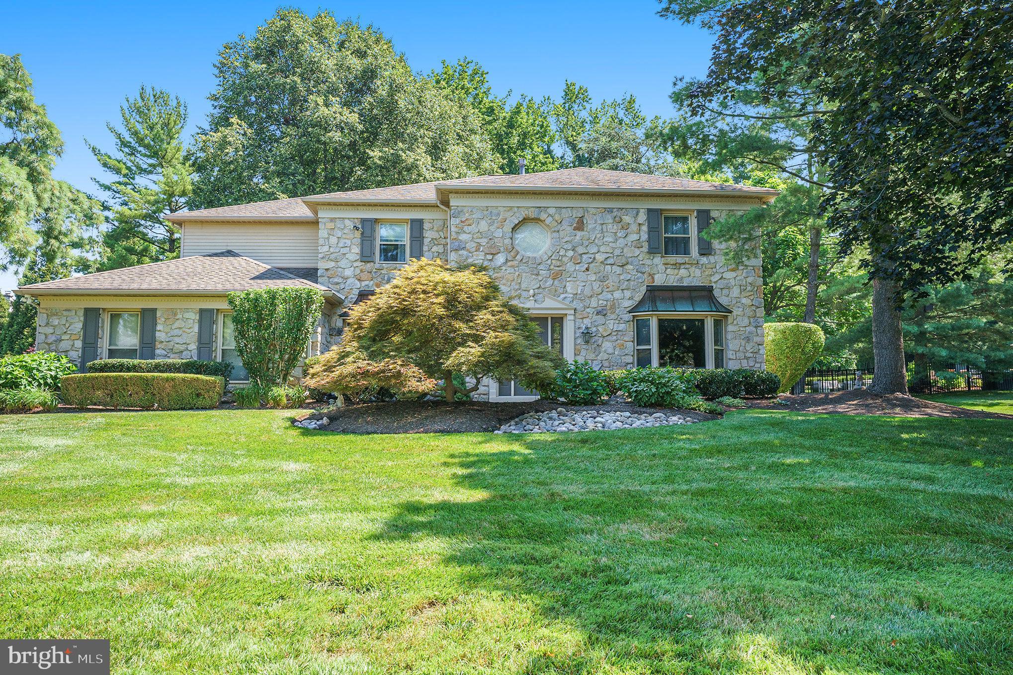 Welcome to this beautifully updated and meticulously maintained home in Lower Gwynedd’s highly desirable Gwynedd Hill community—offering one of the larger, flatter, and more private lots in the neighborhood, backing to serene woods for added tranquility and space. Located within the top-ranked Wissahickon School District, the home is just a short walk to the Lower, Middle, and High Schools, Pen Ambler Park, and the walking trails that connect to the broader township path system. The location also offers walkability to the charming borough of Ambler, regional rail, and a vibrant downtown with restaurants, shops, and community events—all with the added bonus of low taxes. Inside, the home showcases a brand-new kitchen with high-end quartz countertops, a Bosch refrigerator and whisper-quiet dishwasher, an induction range, and thoughtful finishes throughout. The living room features a new remote-controlled gas fireplace, while additional style upgrades include newly installed wood flooring, updated powder room, custom trim and molding, and freshly painted walls in many rooms. A brand-new washer and dryer add convenience to everyday living. The mudroom has also been redesigned for function and flow, and the entire rear yard is newly fenced—perfect for children and pets. Upstairs, the primary suite offers a true retreat, featuring a large sitting room, custom walk-in closets, and a beautifully updated en-suite bath with dual vanities, a frameless glass shower, and radiant heated floors. A newly installed skylight with a remote-controlled blackout shade adds natural light by day and comfort at night. Three additional bedrooms share a well-appointed hall bath with a tub-shower combination. The finished basement offers additional living space—ideal for a media room, gym, home office or play room. A heated and cooled four-season room seamlessly connects the indoors to the private backyard, offering year-round comfort and relaxation. This home brings together timeless design, thoughtful updates and an unbeatable location in an excellent neighborhood which holds multiple community gatherings throughout the year. Schedule your tour today to see all this beautiful home has to offer.