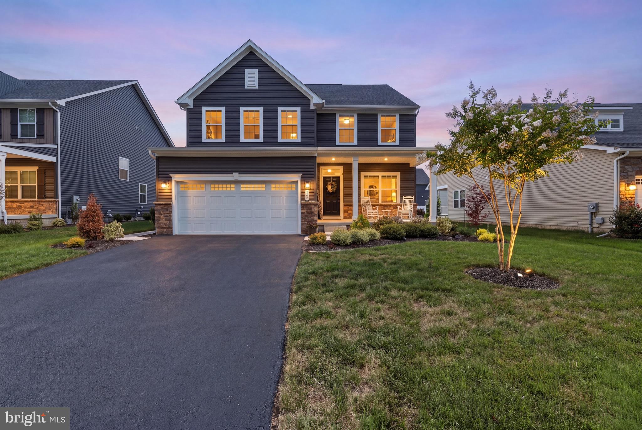 Welcome to 504 Rushbrook Drive, where modern design, thoughtful upgrades, and meticulous care come together to create a truly move-in-ready home. Built just three years ago and impeccably maintained, this beautiful residence is located in the highly sought-after Lakes at Martinsburg community, offering the perfect combination of comfort, style, and convenience. As you arrive, you'll immediately notice the recently sealed driveway leading to the spacious attached two-car garage. Beautifully landscaped grounds and an inviting covered front porch create outstanding curb appeal and provide the perfect place to relax while enjoying the peaceful surroundings. Step inside to a welcoming foyer with a spacious hallway that immediately sets the tone for the home's open and airy feel. To the right, a bright and elegant home office is filled with natural light from large windows, creating an ideal workspace for anyone needing a quiet retreat. Continue down the hall into the heart of the home, a stunning open-concept living space designed for both everyday living and entertaining. The kitchen is truly the centerpiece, featuring striking black cabinetry, beautiful granite countertops, stainless steel appliances, abundant cabinet space, and a layout that seamlessly connects to the dining and living areas. The adjacent dining room offers flexibility for family meals, holiday gatherings, or additional entertaining space, while the expansive living room provides plenty of room to relax and unwind. Sliding glass doors lead to a large trex deck overlooking the beautifully maintained backyard. The outdoor space is complete with a vinyl privacy fence and recently planted trees that will continue to mature, creating an even more private setting for outdoor entertaining, children, pets, or peaceful evenings at home. Conveniently located just off the kitchen are the garage entrance and a well-appointed half bathroom, making daily living both practical and efficient. Upstairs, you'll find four generously sized bedrooms, including a spacious primary suite featuring vaulted ceilings, a large walk-in closet, and a luxurious en-suite bathroom complete with a dual vanity, soaking tub, and glass-enclosed walk-in shower. Each additional bedroom offers abundant natural light, ample closet space, and easy access to a full shared bathroom. Completing the upper level is a conveniently located laundry room, eliminating the hassle of carrying laundry between floors. The finished lower level adds exceptional versatility to the home. Featuring plush carpeting, a full bathroom, and an egress window providing natural light, this space can easily serve as a recreation room, home theater, playroom, office, or guest suite. Adjacent to the finished area is a dedicated workout space that could also be used as additional storage, along with a separate unfinished storage room offering plenty of space for seasonal items and household essentials. With modern construction, quality finishes, and only three years of ownership, this home offers the peace of mind that comes with newer construction while eliminating many of the concerns associated with older homes. From its stylish interior and functional floor plan to its exceptional outdoor living space and desirable location, 504 Rushbrook Drive is ready to welcome its next owners. Don't miss your opportunity to own this exceptional home—schedule your private showing today!