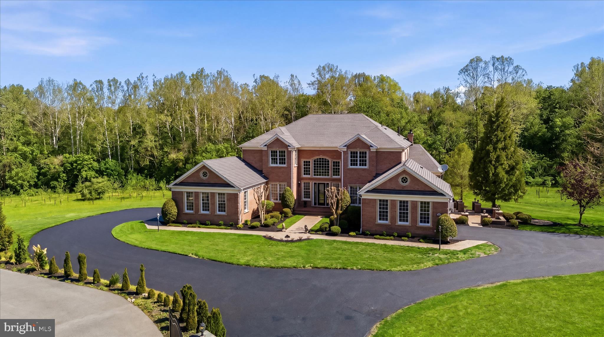 ELEVATED ESTATE HOME, IN-GROUND POOL, & PROFESSIONAL OFFICE
Exceptional Toll Brothers estate in Homewood Crossing offering nearly 10,000 finished square feet on 1.28 private acres with an extraordinary walk-out professional office suite ideal for medical, wellness, legal, accounting, consulting, or executive business use.  This property is impeccably appointed with upgraded lighting, upgraded baths and a stunning upgraded kitchen. Highlights include 6 bedrooms, 5 full baths, 3 half baths, two side-load garages, offering 4 parking bays, and intentional indoor and outdoor living spaces designed for both elegant entertaining and elevated multi-functional living.
A dramatic two-story foyer welcomes guests with marble flooring, contrasting border, double curved staircase, and designer lighting. Rich hard wood floors extend throughout three levels, including bedrooms. The gourmet kitchen is fully upgraded and curated with quartz waterfall countertops, sparkling backsplash, center island, breakfast bar, stainless steel appliances, gas cooking, water filtration system, pendant lighting, and a spacious walk-in pantry. The adjoining skylit breakfast area features an atrium door to access to the side dining deck, while the expansive family room showcases a vaulted ceiling and gas fireplace. 
Additional main-level highlights include a sunroom with French door entry and rear deck access, an impressive conservatory with marble flooring, vaulted ceiling, and three walls of windows, plus a desirable main-level en-suite bedroom with private entry and upgraded bath.  The luxurious upper-level primary suite offers hardwood floors, a sitting area, two-sided gas fireplace, and a fully renovated spa-inspired bath. Three additional upper-level bedrooms include generous closets and a private en-suite configuration.  The finished lower level is designed for entertaining and recreation with an expansive wet bar, theater/media room with riser for seating, ambient wall sconces, fitness room, sixth bedroom, and full bath.
The standout feature of this exceptional property is the fully finished walk-out professional office suite with its own dedicated private parking area, rear entrance, private patio access, reception area, waiting room, ADA-compliant half bath, three patient/exam rooms, kitchenette, office space, and large storage closet. Perfect for business owners seeking a seamless live/work environment or private client-facing workspace with excellent separation from the main residence.  Outdoor amenities include a private drive, brick and cast stone exterior detailing, front and side porches, rear deck, covered lower patio, and fenced in-ground pool creating a private resort-style setting.  Conveniently located in Ellicott City with easy access to major commuter routes, shopping, dining, and top-rated schools. Rarely does a property combine refined living and professional functionality with discreet exclusivity at this level. Come home to elevated upgrades in this amenities-rich Toll Brothers home crafted with effortless sophistication and endless lifestyle options.
