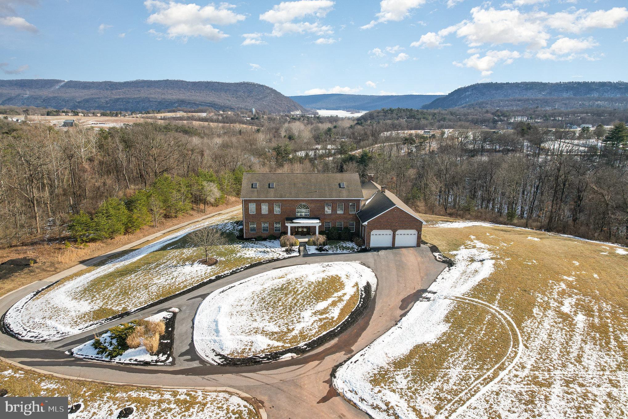 Discover luxury, privacy and serenity in this exceptional 6,430 sq. ft. home situated on 23.71 acres in Penn Twp. Designed for both comfortable living and entertaining, this property offers unparalleled amenities, spacious interiors, and breathtaking outdoor spaces with sweeping mountain and river views.

Step inside through the custom front door into the grand foyer adorned with a sophisticated drop-down chandelier. The heart of the home is the chef’s kitchen, boasting a 10-burner Viking cooktop, an expansive island, breakfast bar, pantry, and three dishwashers, making meal prep and cleanup effortless. The formal dining room provides a refined setting for gatherings, while the family room features 12-foot ceilings, and a cozy wood-burning fireplace. A private office on the main level offers a quiet retreat for work or study.

Upstairs, the primary suite is a private oasis, featuring skylights, a spa-like bath with a waterfall, a spa tub, and a luxurious shower equipped with (18) multiple shower heads. Two additional bedrooms, each with their own full bath and skylights, ensure comfort and privacy for family or guests. A versatile loft adds space for reading, gaming, or relaxing.

The finished lower level elevates entertainment with a media room, recreation room, and a wine room. An attached, heated 2-car garage provides convenience and comfort year round. Step outside to enjoy the expansive yard, ideal for recreation or simply taking in the stunning natural surroundings. The paver patio offers a perfect vantage point to appreciate the panoramic mountain and amazing river views.

For the hobbyist, car enthusiast, or entrepreneur, the property also includes a 40x60 detached heated workshop. Complete with electricity, multiple garage doors, and endless potential, this space is perfect for projects, storage, or pursuing your passions.

Additional highlights of this impressive property include dual staircases for seamless flow, remote-control skylights with rain sensors, zoned (9 zones) heating for optimal comfort, recessed lighting throughout, central vacuum, a water softener, and an 80-year shingle roof for peace of mind.  Commercial quality construction!

Whether hosting gatherings, enjoying quiet evenings, or exploring the vast acreage, this property delivers a lifestyle of luxury and tranquility. A truly remarkable home that must be experienced to be fully appreciated.  NOTE: The current oil burner be replaced with regular oil burner - which would be a lot quieter.  The current burner has an air compressor which is most of the noise and will not be part of the new burner.  There is a wood stove in the basement that could be set up and there are pipes run through the house in case they want to build a gas fireplace.  Furnace in detached or exterior garage is a newer propane furnace.