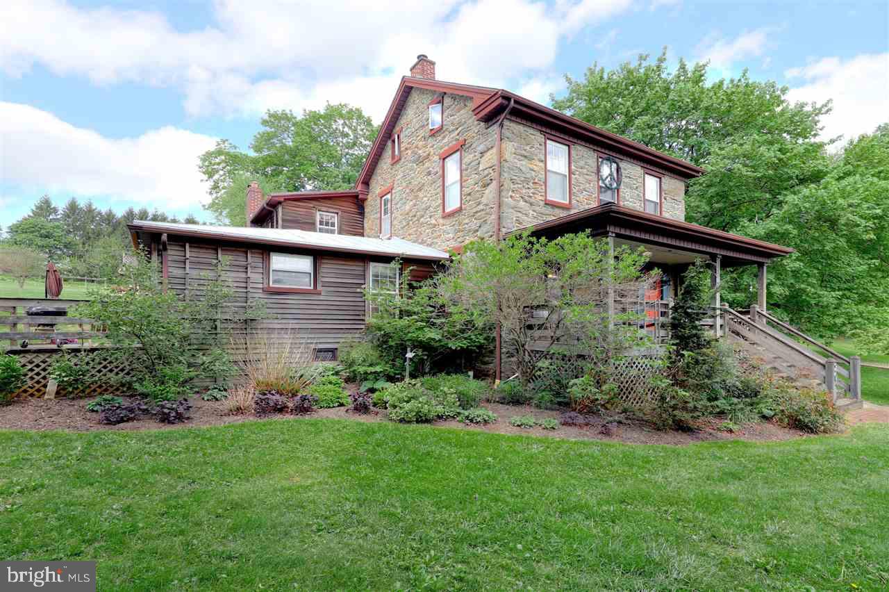 An amazing find in Southern York County! Early 1900's Stone Farmhouse with  mid-century addition. Many upgrades including fresh paint, natural gas boiler, & brand new roof! Master suite w/ full bath. Updated kitchen and baths. Enjoy the large .82 acre yard or relax on 1 of 4 patios/decks. Attached addition currently used as art studio & storage. Cross the street and enjoy the local park and Rail Trail access. Minutes to I-83 and Maryland.