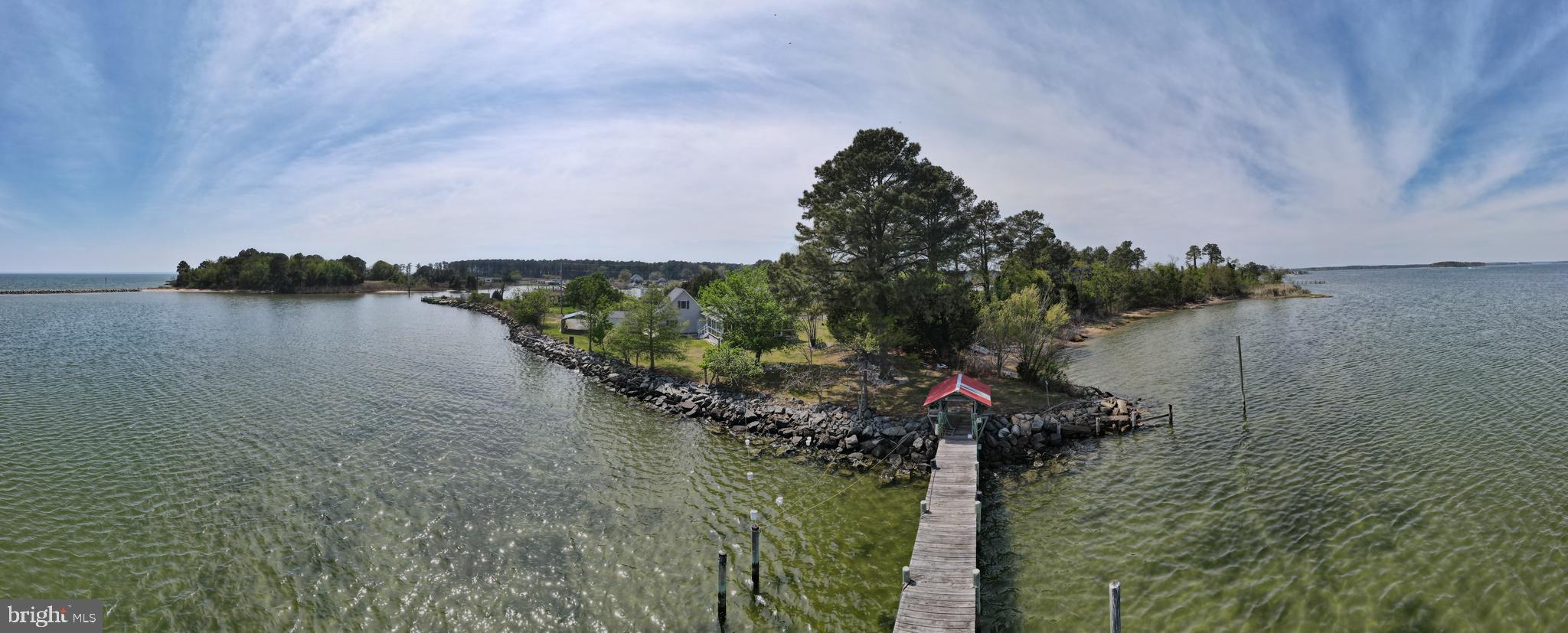 Welcome to your waterfront escape on the point of St. George Island, where the Potomac River meets the Chesapeake Bay.
This home was built by the local Amish community for this family. 
This rare offering features 154 feet of riprapped shoreline, delivering sweeping water views and front-row seats to breathtaking sunrises, passing boats, and endless coastal serenity.
The main home offers 4 bedrooms and 1.5 baths, with water views from both the kitchen and living room, creating a daily backdrop that never gets old. The updated kitchen features granite countertops and an eat-in area, perfect for casual dining while overlooking the water. A wraparound screened porch invites you to relax, entertain, and enjoy the bay breeze in every season.
For boating enthusiasts, the property is fully equipped with a private pier, electric, and boat lift, making it easy to get out on the water at a moment’s notice.
Additional features include:
Detached garage with apartment above and full bath – ideal for guests, rental income, or private workspace
Carport and shed for added storage and functionality
New HVAC systems in both the main home and garage
Public sewer recently installed (approx. $48,000 investment)
Deep well
.36-acre lot with mature fruit trees
Whether you're looking for a full-time residence, weekend retreat, or income-producing opportunity, this property offers the perfect blend of waterfront living, versatility, and long-term value.
Opportunities like this—on the point, with this much frontage—don’t come around often.